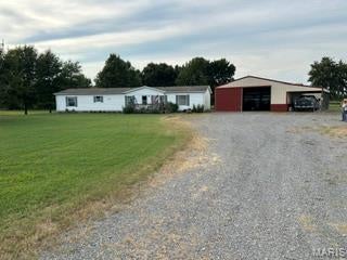 Welcome to this spacious 4-bedroom, 2 1/2-bathroom modular home nestled on a beautiful acreage property!  Offering plenty of room inside and out, this property is ideal for those looking for space, privacy, and the flexibility to enjoy country living.  The home features a comfortable layout with generously sized bedrooms, ample living space, and 2 1/2 bathrooms.  Outside, the acreage provides endless possibilities for recreation, gardening, animals, or simply enjoying the peaceful surroundings.  Several outbuildings offer excellent storage and workspace for hobbies, equipment, or additional needs.  With its combination of acreage, outbuildings, and a spacious home, this property offers a rare opportunity to enjoy the best of rural living while creating a place to call your own.