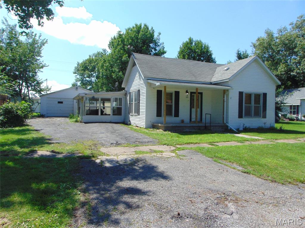 This is a nicely kept two bedroom home with an updated bathroom. The kitchen and dining room have an open floor with a separate laundry area  and there is also a large living room for you to relax. The driveway is asphalt to the garage door and there is additional car storage with the detached carport for your car or camper in the backyard with alley access. Don't forget you can enjoy the afternoons and evenings in the enclosed porch too.