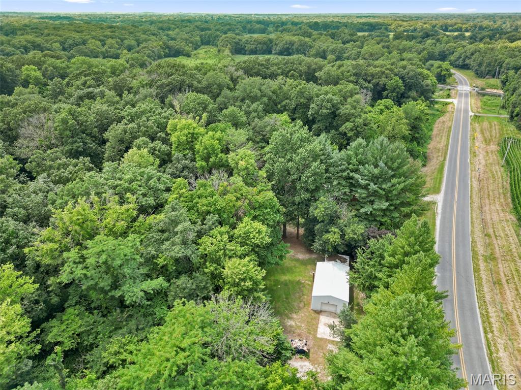 Fantastic opportunity to own approximately 5 acres in the Hillsboro School District, conveniently located along the Montgomery and Bond County line. This versatile property offers multiple excellent building sites for your dream home while also providing plenty of space for recreation, hunting, or simply enjoying the peaceful wooded setting.
While the land is the primary value, the property also includes several useful improvements. A 20' x 32' pole-style garage features 220-volt electrical service, a partial concrete floor, and a wood-burning stove. Additional improvements include a 14' x 15' rear lean-to ideal for equipment or firewood storage, a 10' x 10' lean-to, a chicken coop, and a 22' x 16' two-stall horse barn. Public water, Ameren natural gas, and Ameren electric service are already on site.
Also included is a 1997 Mid America mobile home offering 3 bedrooms and 2 bathrooms. The home needs TLC and is being sold as-is. Seller will make no repairs. Whether you choose to renovate the home, remove it to build your dream home, or simply enjoy the acreage and existing outbuildings, this property offers outstanding potential in a beautiful country setting.