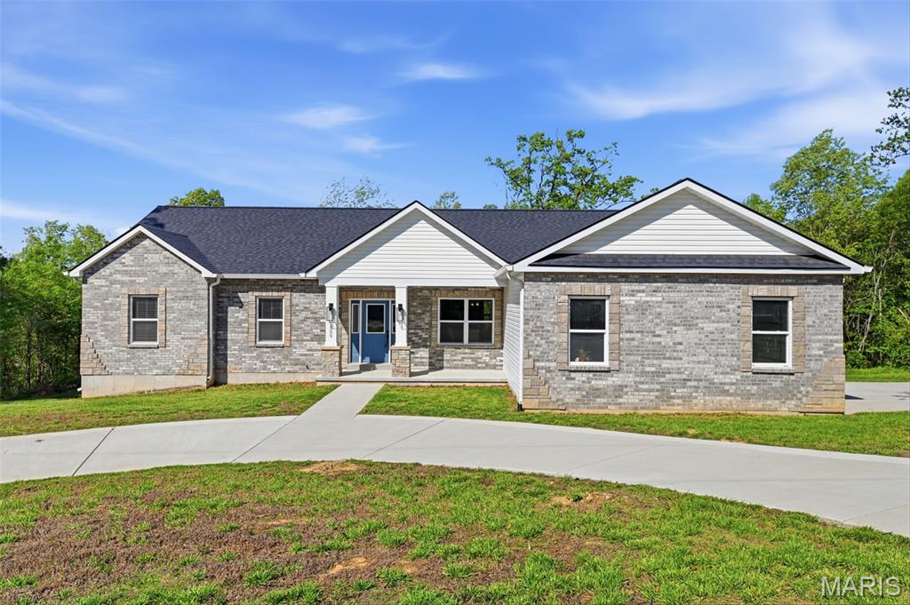 BACK ON MARKET WITH FULL INSPECTION AVAILABLE — no material defects or issues found. Buyer's circumstances changed, but the home did not: like-new, move-in ready, and now with complete documented inspection for added peace of mind.

Luxury meets privacy on 2 wooded acres in Festus. This 2023 custom-built ranch showcases refined design and effortless living with an open-concept layout, LVP floors, and exceptional natural light. The chef’s kitchen impresses with custom cabinetry, granite countertops, a statement island, and upgraded appliances, flowing seamlessly into the great room with a gas log fireplace.

The main level offers 3 spacious bedrooms, 2 designer baths, and convenient main-floor laundry, including a serene primary suite retreat. Step outside to an expansive deck overlooking a private, wooded backdrop—perfect for quiet mornings or elevated entertaining.

Additional highlights include an oversized 3-car garage with stunning custom doors, dual driveways with a circular drive, striking brick exterior, and a full walk-out lower level ready for your custom vision.

A rare blend of modern luxury, privacy, and future potential—just minutes from town.