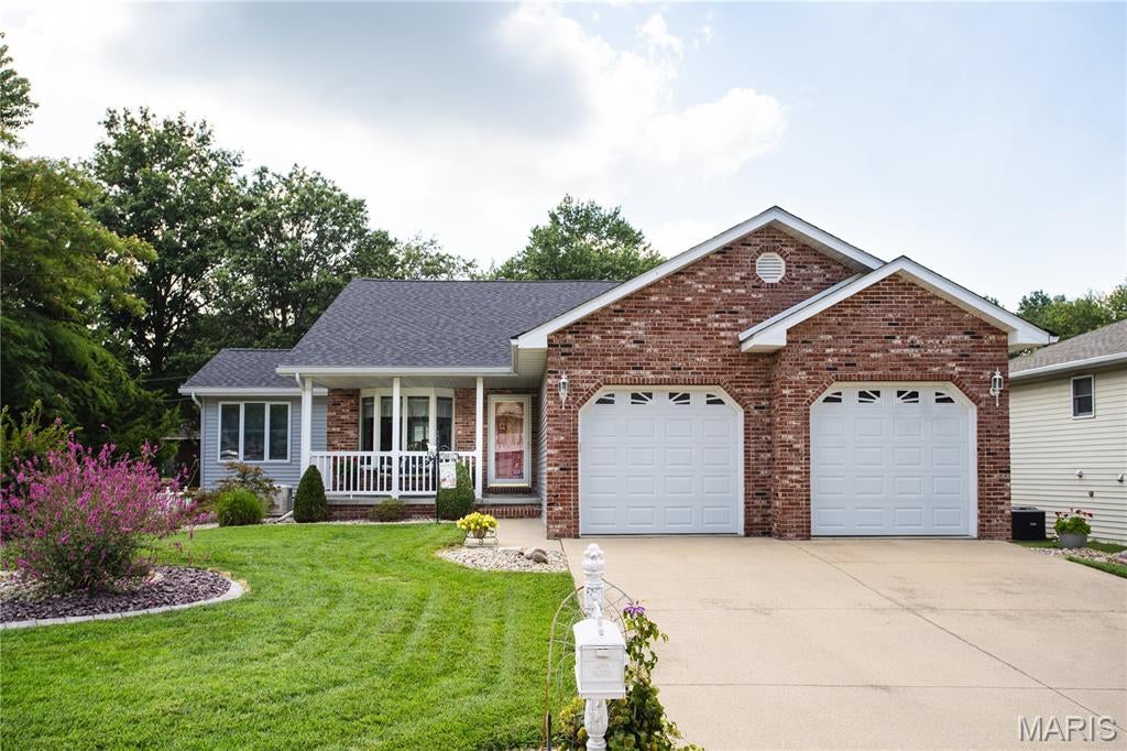 Don't miss out on this well-maintained, beautifully landscaped home on a cul-de-sac street.  Built in 1999, this home sits on a lakefront lot with its own boat dock off of the maintenance free, three-tiered deck with a pergola.  It features a large living room with a gas fireplace, kitchen with stainless steel appliances and Quartz countertops and a large all-season sunroom.  Two car garage with attic access for extra storage and a nice covered front porch with maintenance free railing.  New roof and siding installed in 2025.  Extra features include gutter guards, 2 X 6 exterior walls, Generac Whole House Generator, Vacuflo whole-house central vacuum system, and beautiful inside shutters on all interior windows.    Lower level has large finished family room, office with a walk-in closet and full bathroom. If  the buyer installs an egress window, office could be used as a bedroom.  Lower level has an unfinished room currently used as workout room and a large unfinished area for storage.  Lake assessment fees have been $175 annually.  Open House Sunday August 30th 1-3pm.