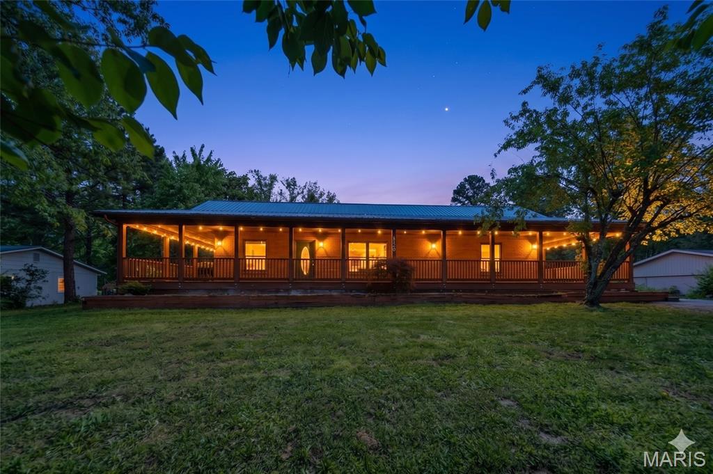 STILL ACCEPTING OFFERS - Tucked away on a quiet cul-de-sac just outside of Rolla, this charming 3 bedroom, 2.5 bathroom cedar-sided home sits on a spacious 0.4 acre lot m/l, offering both privacy and convenience. An inviting wrap-around porch welcomes you inside to an open floor plan highlighted by tall ceilings and abundant natural light. The kitchen features a convenient breakfast bar, perfect for casual dining or entertaining, while the home offers generously sized bedrooms with walk-in closets throughout. The primary suite provides a comfortable retreat with a walk-in closet and a full ensuite bathroom. The home boasts a new metal roof.  Outside, you’ll find an oversized 2-car detached garage complete with heat, air conditioning, and a dedicated workshop area—ideal for hobbies, storage, or projects year-round.  With its peaceful setting and desirable features, this property offers the perfect blend of comfort and functionality.