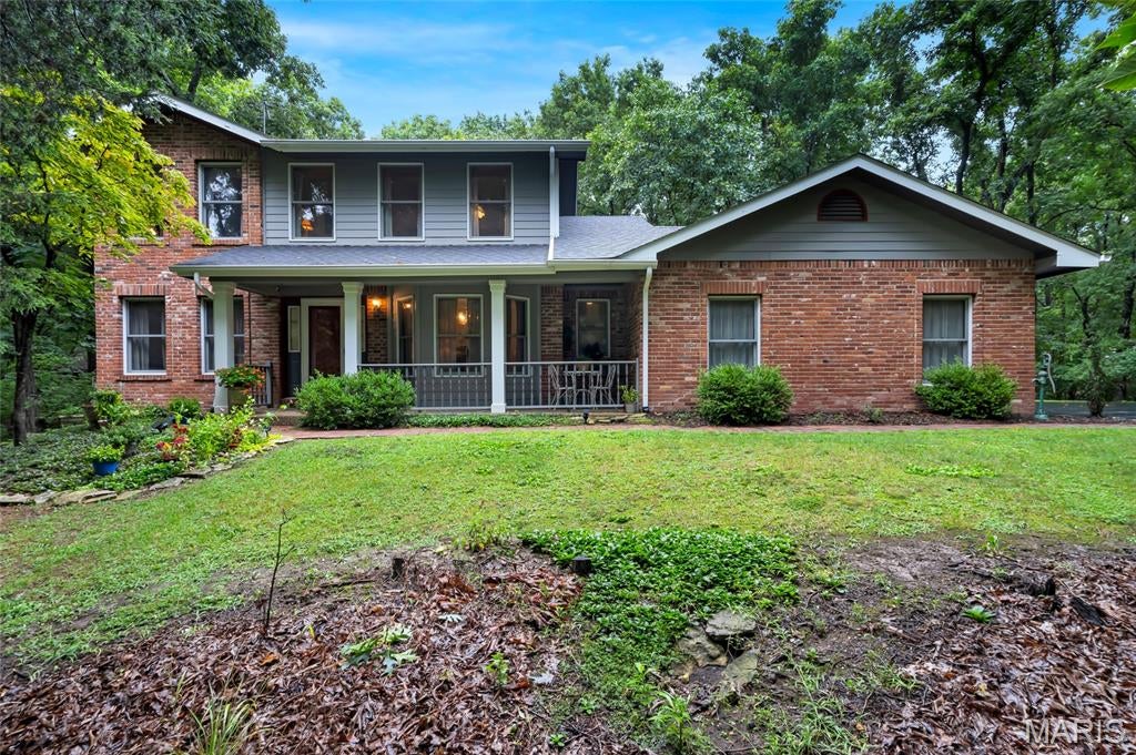 Welcome to this beautiful 2-story home nestled on 3.9 private acres in the heart of Defiance. Offering 3 bedrooms and 2.5 baths, this property combines peaceful country living with timeless charm.
The bright, inviting kitchen features white cabinetry, a center island with an electric cooktop, hardwood floors, and plenty of workspace for cooking and entertaining. The convenient main floor laundry adds everyday ease and functionality. Just off the kitchen, the warm and welcoming family room is the perfect gathering place, showcasing hardwood floors, a wood-burning fireplace, custom built-in shelving, and elegant crown molding.
Upstairs, you'll find three spacious bedrooms, including a comfortable primary suite with a private bath. A newer roof (2 years old) provides added peace of mind for the next owner. 
Step outside and enjoy the privacy and beauty of 3.9 acres, offering endless opportunities for outdoor entertaining, gardening, exploring nature, or simply relaxing in the peaceful surroundings. The home also features an oversized 2-car side-entry garage, providing ample space for vehicles, storage, and hobbies.
If you've been searching for a private retreat with acreage, timeless character, and room to enjoy the outdoors, this exceptional property is ready to welcome you home. Just minutes from Missouri Wine Country, the Katy Trail, Klondike Park, and some of the area's most popular wineries, restaurants, and outdoor recreation. Property is being sold as-is. Seller has a bid from Helitech for basement waterproofing and wall braces, which is available upon request.