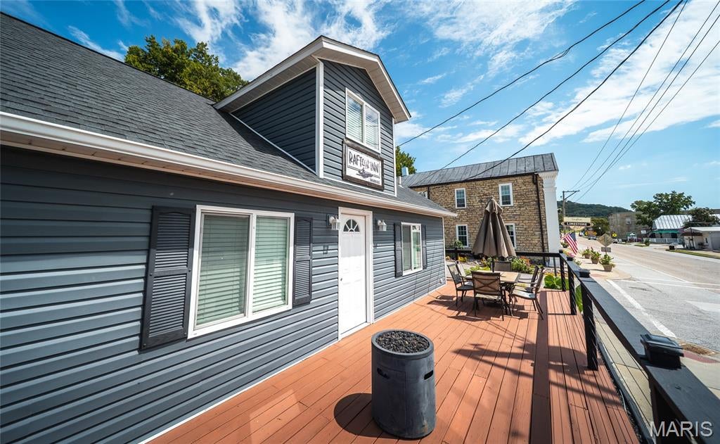 Welcome to the RAFTON INN, a one-of-a-kind turn-key business opportunity right in the heart of Grafton. This beautifully remodeled and fully furnished 3-bedroom, 2-bath home is currently set up to comfortably accommodate up to 12 guests and is zoned for both commercial and residential use. Just behind the home, you’ll find a separate building with three individual units, each featuring two queen beds, a full bath, kitchenette, dining space, and TV—accommodating up to 12 additional guests. The property is located outside of the flood plain and does not require flood insurance. With its stylish updates, thoughtful layout, and high-traffic location, this property will generate income from day one. Whether you continue it as a short-term rental, use it as a private retreat, or explore another business opportunity, this property has it all and is ready to start working for you.