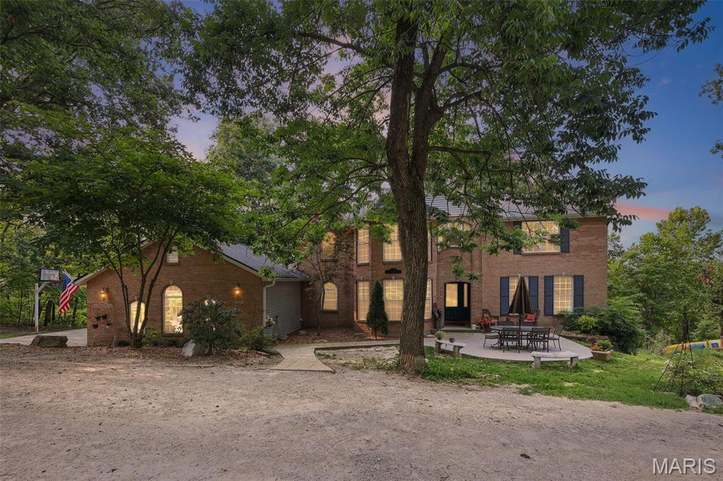 Escape to your own private, secluded retreat on 6.98 acres with a 5 bedroom, 4 bath home featuring wooded views, a pond, creek, and plenty of room to enjoy the outdoors. This beautiful property also includes a 3 car attached garage, a large playset, and a concrete slab ready for a future outbuilding. 

Step inside the foyer and be welcomed with elegant columns, and a formal dining room just off the entry. The family room features 11 foot ceilings and large windows that fill the home with natural light while showcasing the surrounding landscape. 

The kitchen offers a large dining area, center island, pantry, and a cozy hearth room with a fireplace, perfect for gathering with family and friends. Just off the kitchen, the covered deck provides the ideal place to relax and take in the wooded views. The main level also features a bedroom, half bath, and laundry room. 

Upstairs, the impressive master suite features a vaulted ceiling, spacious walk in closet, and private en-suite bathroom. Two additional bedrooms share a Jack & Jill bathroom, offering both comfort and functionality. 

The walk out basement provides flexibility with an additional bedroom with private entry, finished bathroom, and an abundant unfinished space ready to be transformed into additional living, entertaining, or recreation areas to fit your needs.  

A rare opportunity to enjoy privacy, beautiful surroundings, and room to grow.