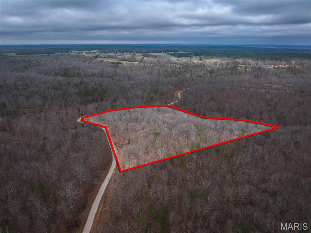 Beautiful 11.09 acres of wooded vacant land located in the Golden Hills Equine Community in Raymondville, MO, offering privacy, natural beauty, and endless possibilities. This heavily wooded tract provides a peaceful setting with abundant wildlife, making it perfect for a private homesite or recreational getaway. Enjoy the tranquility of the Ozarks while still having convenient access to nearby towns and amenities. Golden Hills is designed with horse owners and outdoor enthusiasts in mind, featuring trail easements throughout the community. This parcel offers the perfect setting for a walk out basement for private access to mother-in-law quarters, or a patio perfect for social gatherings.  Whether you are looking to build your dream home, create a weekend escape, or invest in land, this property offers a wonderful opportunity to enjoy country living with room to roam.