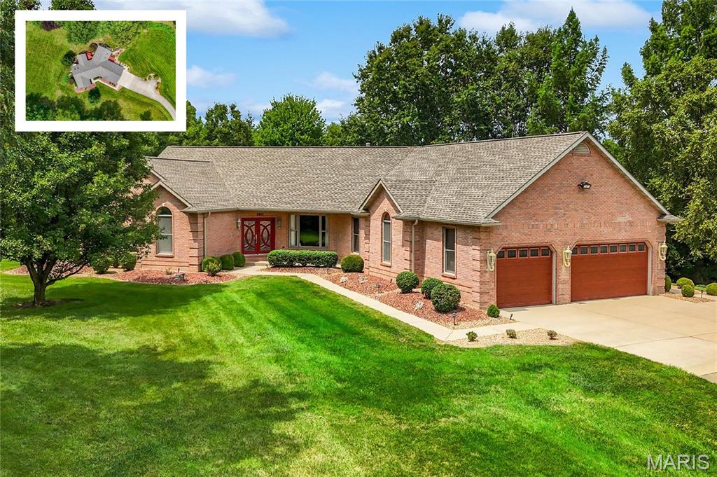 Beautiful, move-in-ready home on a private 2+ acre professionally landscaped lot in the Covenant at Steeplechase neighborhood, within the O’Fallon School District. Surrounded by mature trees, this exceptional property offers spacious indoor and outdoor living, extensive upgrades, and outstanding storage throughout.

The main level welcomes you with a custom staircase, soaring ceilings, skylights, 9-foot ceilings, and stunning real oak floors with a rich stain. The open family room features a gas fireplace and access to an oversized covered deck with stairs leading to the backyard. A separate dining room, half bath, garage drop zone, and side hot tub deck add everyday convenience.

The well-appointed kitchen offers abundant granite counter space, never-used appliances, a gas cooktop, convection oven, microwave, refrigerator, and dishwasher. The massive main-level laundry room provides access to both the rear deck and the primary suite closet.

The split-bedroom floor plan includes two guest bedrooms, each with a private en-suite bath and walk-in closet. The spacious primary suite features double-door entry, vaulted ceilings, abundant natural light, a huge walk-in closet, and a luxurious en-suite bath with double vanity, makeup counter, linen closet, separate shower, and jetted corner tub framed by quarter windows overlooking the private landscape.

The oversized, finished three-car garage includes 8-foot doors, attic access, its own gas heat source, and a newly installed EV charger.

The finished walkout lower level is accessible from both the main entry staircase and rear staircase near the garage. It offers an oversized patio, large family room with fireplace, office nook with built-in shelving and upgraded cabinetry, second laundry hookup, and a full kitchen with solid countertops, raised-panel glazed cabinetry, range, microwave, refrigerator, dishwasher, and island bar seating. A pass-through full bath with tub/shower, oversized vanity, and linen storage connects to a guest bedroom with walk-in closet.

Additional highlights include dedicated unfinished storage and a converted fourth basement garage that is currently finished space but may be converted back to a single-door garage with exterior sidewalk access. Major mechanical updates include a newer Carrier Infinity HVAC system with dehumidifier and oversized filtration, a second Carrier Infinity system, and two gas water heaters. A rare combination of privacy, flexibility, and quality finishes in a sought-after O’Fallon location.