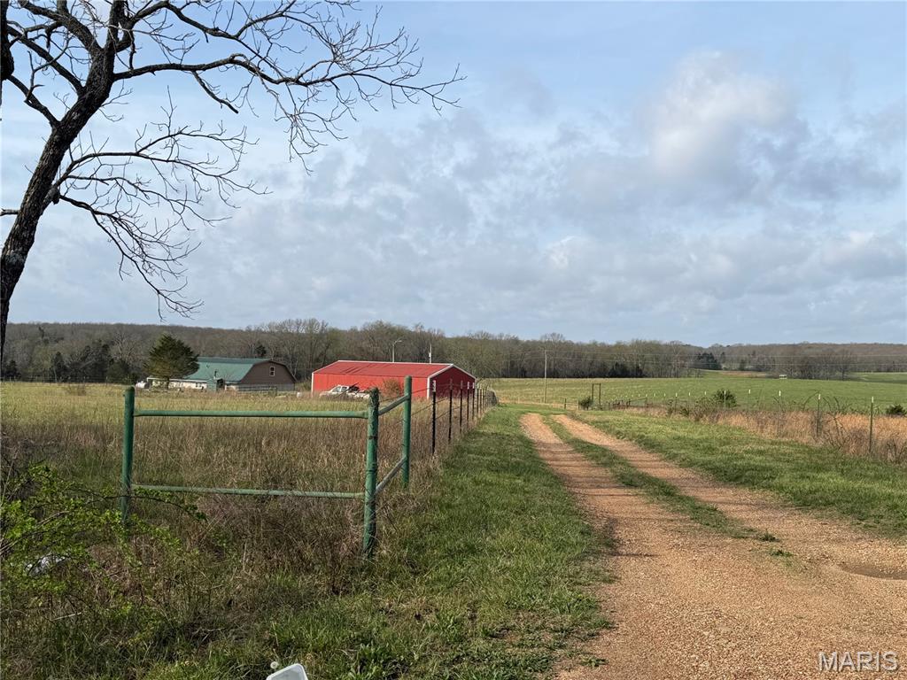 Discover the perfect blend of efficiency, space, and rural charm with this unique 4-bedroom, 1.5-bath earth berm home set on 13.22 acres of mostly open pasture. Designed with energy efficiency in mind, this home offers comfortable year-round living.
The main level features three bedrooms, a full bathroom, and a spacious living and dining area centered around a cozy pellet stove, ideal for gathering and relaxing. You’ll also find a convenient laundry room and a small sitting area, perfect for relaxing. The kitchen provides ample cabinet space and a scenic view. Upstairs, the private primary suite includes a half bath and walk-in closet, creating a quiet retreat. An additional 14' x 35' unfinished space offers endless possibilities, perfect for a future bedroom suite, family room, or bonus living area. Outside, the property is well-equipped for country living. A 24' x 48' metal building provides excellent space for storage, equipment, or a workshop. The land is well-suited for livestock with a working pen and two cross-fenced paddocks, making it ideal for hobby farming or agricultural use. Additional features include an outdoor wood furnace and optional propane heat, offering multiple heating solutions for added flexibility. With functional amenities, and room to make it your own, this property presents a fantastic opportunity to create your ideal rural retreat.