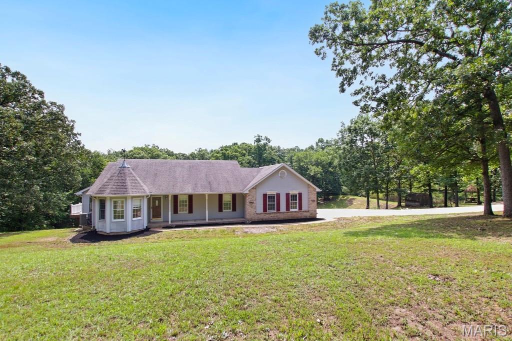 Discover the potential of this 4-bedroom, 3-bath home nestled on 6+/- acres in a private neighborhood. The home features a newly remodeled kitchen, hardwood flooring, a spacious living room with a large wood burning fireplace, and a generously sized primary with en-suite. Main floor laundry adds everyday convenience. The partially finished walk-out basement provides additional living space and plenty of room to expand, with a bedroom and full bathroom. 

The home is equipped with solar panels that have historically covered the current homeowner's electric bill, offering an opportunity for significant energy savings. Outside, enjoy the freshly manicured yard, a handy set of tool sheds, and a beautiful, quiet pond surrounded by the privacy of your acreage. 

With a little TLC, this property has the makings of a dream home. Bring your vision and make the most of the space, acreage, and peaceful setting this property has to offer!
