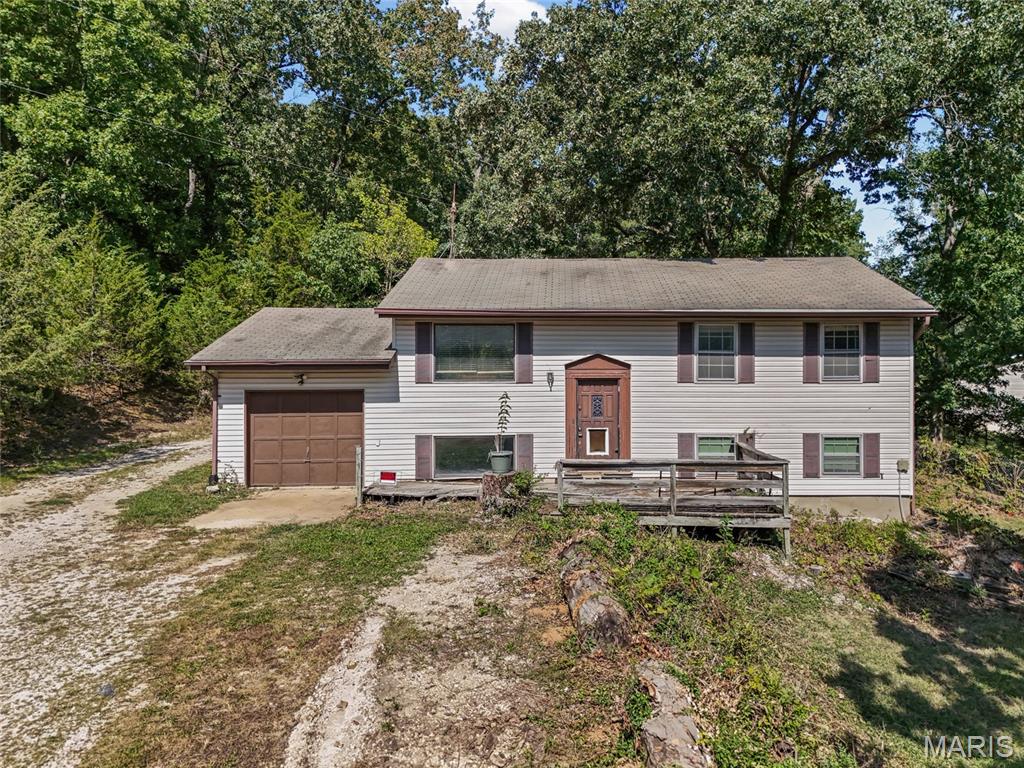 This spacious home sits on a private, corner lot conveniently located in Fenton. This floor plan offers more room than a typical split foyer with 3 bedrooms upstairs and a huge fourth bedroom downstairs. The other half of the lower level provides plenty of space for a second family room or rec room. Plus, a huge storage area! Head outside to enjoy the large covered deck and private 3/4 acres lot with partial fencing. Don't forget to check out the 12 x 32 shed in the back! **New A/C**