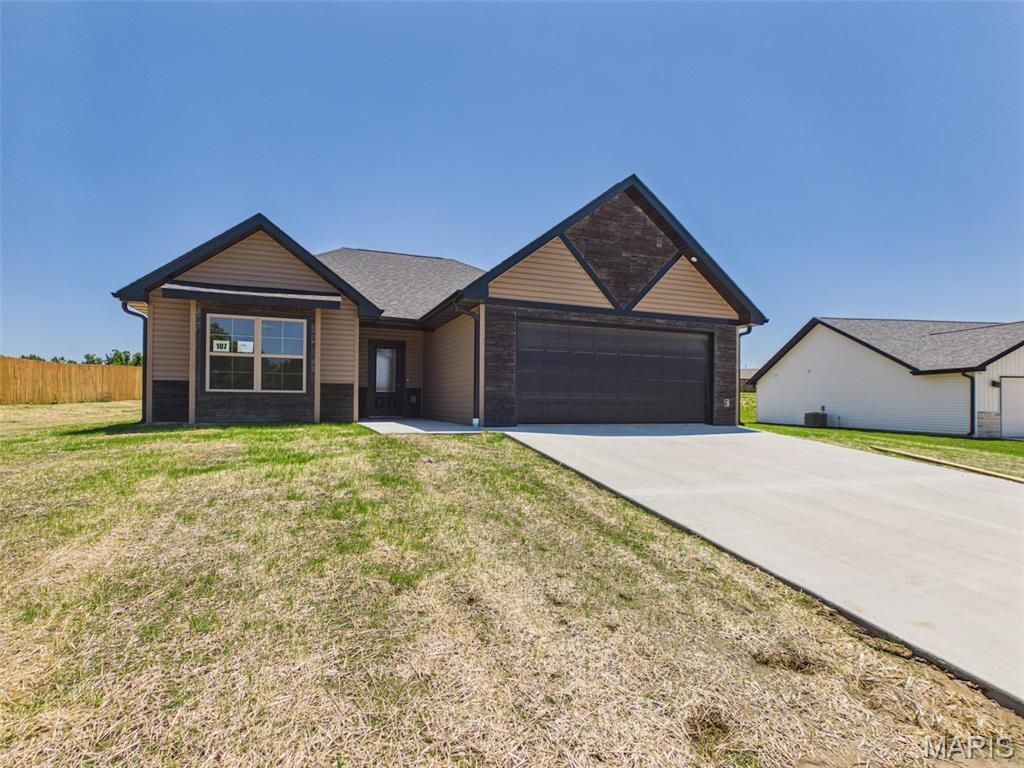 MODERN DESIGN. EXCEPTIONAL QUALITY. MOVE-IN READY. Welcome to The Colette, Summit Pass Subdivision's newest and most distinctive floor plan by Cox & Co Custom Homes, LLC. This is the builder's ONLY move-in ready home currently available, offering today's most sought-after finishes, thoughtful upgrades, and the confidence of a One-Year Builder Warranty—something comparable resale homes simply cannot offer. Priced at just $309,900, this exceptional opportunity delivers brand-new construction with premium finishes for only slightly more than neighboring homes that are already 2-3 years old and no longer include builder warranty protection. Demand is expected to be high, so don't wait.

From the moment you arrive, you'll appreciate the home's striking curb appeal. The carefully selected combination of rich tan siding accented by bold black trim creates a sophisticated, modern exterior that immediately stands apart. Situated on a generous .37 m/l acre mostly level lot, the yard has been professionally prepared with sifted river-bottom soil, fertilizer, premium grass seed, and protective mesh netting to promote a lush, established lawn just in time for closing.

Step inside and prepare to be impressed. The inviting foyer opens into an expansive vaulted living room where two beautifully stained decorative beams perfectly complement the custom cabinetry throughout the home, creating warmth and architectural character. Luxury Vinyl Plank (LVP) flooring extends throughout every room, providing both durability and effortless maintenance without the interruption of carpet.

The open-concept layout was thoughtfully designed for everyday living and entertaining. The spacious living area flows seamlessly into the stunning kitchen featuring custom soft-close cabinetry with dovetail construction, sleek granite countertops, an oversized center island, large undermount stainless steel sink, and upgraded champagne bronze cabinet hardware. The elegant black and champagne bronze interior door hardware coordinates beautifully throughout the home, creating a cohesive designer-inspired aesthetic.

One of The Colette's signature features is its dedicated dining room—a true showpiece rarely found in homes of this size. Anchored by a glossy shiplap ceiling and highlighted with a stunning modern black and gold chandelier, this elegant space was intentionally designed to be the focal point of the home while providing direct access to the spacious rear patio and backyard. Need a fenced yard? The builder can add one for an additional cost.

The private primary suite offers a luxurious retreat featuring a sophisticated coffered ceiling, modern remote-controlled ceiling fan, spacious walk-in closet with additional built-in cabinetry for storage, and an impressive ensuite bathroom complete with a floating granite vanity, champagne bronze fixtures, beautifully tiled high-gloss walk-in shower, and sleek glass door enclosure.

Two additional generously sized bedrooms offer abundant closet space with double-door closets, while the guest bathroom continues the upscale finishes with another floating granite vanity, champagne bronze faucet, and fiberglass tub/shower combination.

Every detail has been carefully selected to create a home that feels custom, modern, and timeless. Best of all, this home has never been lived in. Everything is brand new, professionally finished, and truly TURN-KEY. Simply unpack and begin enjoying maintenance-free living in the Fort Leonard Wood area's most desirable new communities.

Opportunities like this are rare. With premium finishes, a unique floor plan, exceptional craftsmanship, an expansive lot, and immediate availability, The Colette is expected to go under contract quickly. Schedule your private showing today and experience firsthand why this one-of-a-kind Summit Pass home stands above the rest. Your next chapter begins here! ACT FAST!