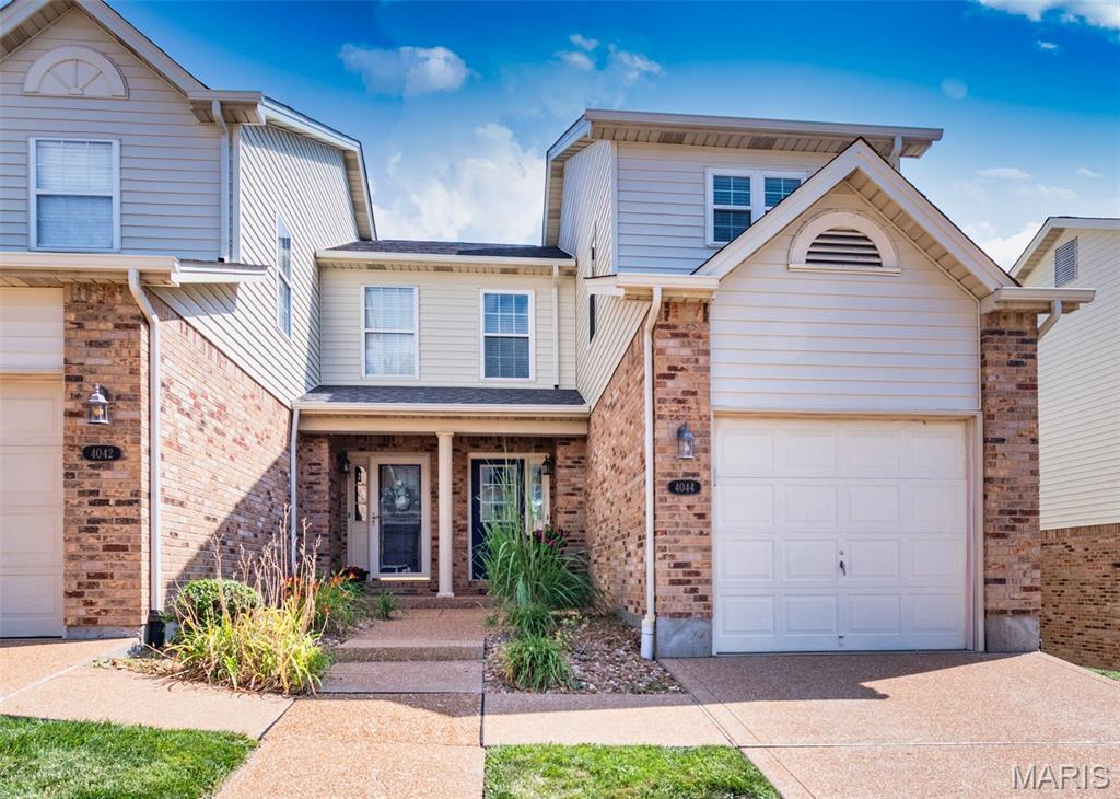Searching for the perfect townhouse?  Well your search ends here! This wonderful end-unit townhouse offers about 1,762 square feet of comfortable living space with 2 primary bedrooms with newer ensuite baths and a half bath.  An        attractive landscaped walkway welcomes you to the covered front porch. Upon entering you will find a foyer with luxury vinyl flooring that opens to the bright and inviting great room.  It features large windows, custom built-in bookcases, and French doors leading to one of the largest decks in the community - an ideal space for relaxing or entertaining while enjoying peaceful views with trees. The adjacent dining area is highlighted by a charming bay window. The  updated kitchen is sure to impress with rich wood cabinetry featuring soft-close drawers, granite countertops, a pantry and stainless steel appliances that are all included. A convenient half bath completes the main level.  Upstairs, you'll find a spacious primary suite that includes a large walk-in closet and a beautifully updated ensuite bath with a walk-in shower and oversized vanity. The generously sized second primary bedroom suite features has an updated private bath with a tub/shower  combination. The finished lower level provides even more  living space with a recreation room complete with a bar that stays, along with a laundry area and storage space. Additional highlights include a new roof (2026), all new windows front and back doors (2020) and  an attached one-car garage, nearby guest parking, and an unbeatable end-unit location. This move-in-ready home combines style, comfort, and convenience—don't miss your opportunity to make it yours!