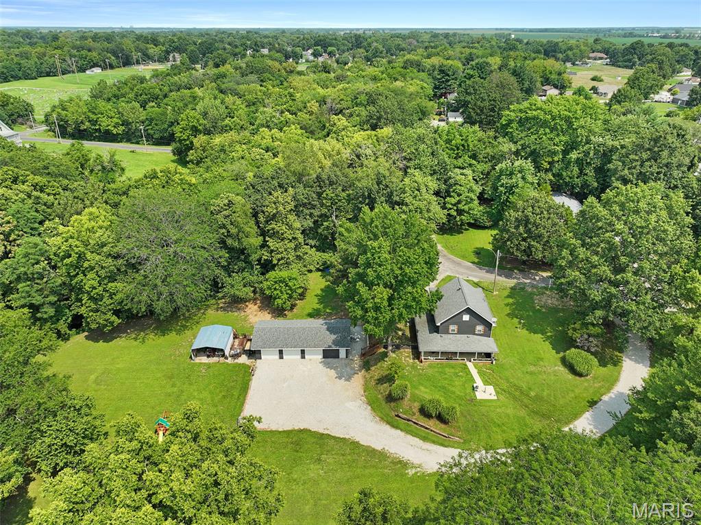 Private Acreage Living in the Heart of the City
Discover the best of both worlds with this 3-bedroom, 2-full-bath home situated on 1.2 pristine acres within city limits. Enjoy the convenience of city living while surrounded by the privacy, peacefulness, and natural beauty of a country setting.
The lower level welcomes you from the parking area with a spacious living room that flows into the modernized eat-in kitchen. The generous living space offers plenty of flexibility for a variety of furniture layouts and could easily accommodate a dedicated dining area. The updated kitchen features refreshed cabinetry and countertops, ample counter space, updated appliances, and room for a comfortable kitchen table and chairs.
On the main level, you'll find a large renovated family room filled with beautiful windows, creating a bright and inviting space that could also serve as a separate entertaining area. The spacious primary suite offers a large walk-in closet and a charming built-in electric fireplace, with plenty of room for both a bedroom and sitting area. Two additional nicely sized bedrooms complete the main living area.
Step outside onto the large walk-out patio and take in the expansive, rolling, meticulously manicured lawn. The property offers a wonderful combination of open yard and wooded areas, creating a private backdrop for relaxing, entertaining, or enjoying the outdoors. The grounds gently meander toward a small creek, providing a unique opportunity to explore and enjoy nature right in your own backyard.
A standout feature of this property is the large detached 3-car garage, located off a private drive and offering generous parking, storage, and workshop space. The garage is heated by a wood-burning stove, which can also provide heat to the main residence as an option.
With its spacious interior, extensive updates, oversized garage, private acreage, wooded setting, and creek—all while remaining within city limits—this property offers a rare opportunity to enjoy privacy and nature without giving up the conveniences of town.