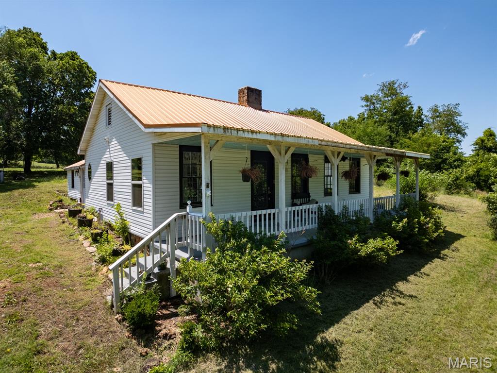 COTTAGE ON THE CREEK has been dressed up and remodeled + renovated to suit your needs.  Located in Historical Dillard Mill, this charming home sits on 6.73 SURVEYED Acres where the beautiful crystal clear Huzzah Creek laps at the property.  Get out of the "hot seat" at work and come sit in this cool Creek or find your Reel and Rod and seek out; Rock/Big Mouth and Smallmouth Bass! Grab the Gun because you have access to 100's of acres of U.S.A. FORESTRY LAND, filled with Bambi, Thumper and hopefully - not Flower!  After a day of hunting or fishing & splashing around in the Creek, come on in to this French Country remodeled and renovated 1900 home that retained all the charm of yesteryear while modernizing to current times.  Rest easy in a spacious kitchen with not only a range but also a special wood stove ready for any chef with the need for fire roasted Pizza & Chicken Dinners! Country Sink, beautiful Center Isle and awesome cabinets and counter tops please your senses.  The living room host an original Rock Fireplace charmed by the hardwood floors, an extra room which was a reading/sleeping room and a beautiful full expanse front covered porch for cool country living.  2 bedrooms, a small cellar, big Livingroom & kitchen, den connected to kitchen and living room ready for a formal dining room as well and small outbuilding just enough for your mini farmette to come to life.  I love to be at this property so schedule your showing today with a Realtor of your choice or, give us a call, we are ready to show you an escape to the countryside.