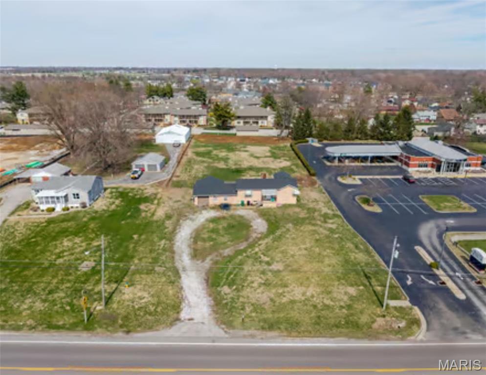Rare 1.06-Acre Opportunity in O’Fallon with Commercial Potential!

Discover the incredible potential of 716 W Highway 50, featuring 120 feet of high-visibility frontage in one of O’Fallon’s most rapidly growing corridors. This sprawling 1.06-acre property offers an unmatched canvas for a strategic development project or a long-term investment. Situated directly adjacent to Scott Credit Union and just minutes from a major interstate exit, the site benefits from an impressive daily traffic count of approximately 19,500 vehicles.

While the property currently includes a 1,028 sq. ft., 2-bedroom, 1-bathroom raised ranch with a fenced backyard and storage shed, the true value lies in the expansive acreage and premier positioning. The location—with a new hotel coming soon and established professional neighbors—presents a prime opportunity for a buyer to pursue rezoning for commercial use. Located within top-rated O’Fallon District 90 and just minutes from Scott Air Force Base, major hospitals, the O'Fallon Sports Park, and shopping, this is a unique chance to secure a significant footprint in a high-demand area. This property is perfectly situated to capitalize on the region's continued future growth.