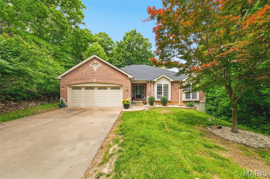 Welcome to this peaceful ranch retreat nestled on approximately 3.18 wooded acres in the highly sought-after Rockwood School District. Surrounded by mature trees and scenic views, this well-loved 3 bedroom, 2.5 bath home offers the perfect blend of privacy, comfort, and everyday functionality. Inside, you’ll find spacious living areas filled with natural light, a large eat-in kitchen with plenty of cabinet space, and a warm, inviting family room with tall ceilings and an abundance of windows looking out at the stunning backyard view of the wooded, rolling hills. The primary suite features a coffered ceiling, bay windows, and its own private bath with double vanities, jetted tub & separate shower, while the additional bedrooms provide generous space for family or guests. The walkout lower level is more than a basement, but an extension of living space with the many egress windows, half bath and french doors. Step outside and enjoy the beauty of nature from the patio while gardening or the expansive side deck overlooking the peaceful wooded setting. Updates include a new roof (2024), new HVAC (2020), new drain field (2017), all new carpet (2026), new kitchen dishwasher & refrigerator, new laminate flooring in lower level (2026), and a new water softener (2025). With a walk-out lower level, oversized garage, and room to make it your own, this property is ideal for anyone looking for quiet country-style living with the convenience of nearby amenities, shopping, and top-rated schools.