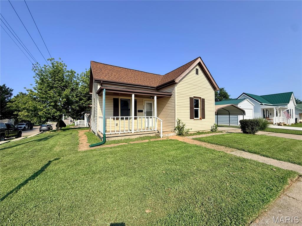 This 2-bedroom, 1-bath bungalow offers 916 square feet of living space and plenty of
potential for a first-time buyer, investor, or anyone looking for an affordable place to call
home. Built in 1928, the home has seen several important exterior improvements over
the years, including replacement siding, windows, and roof, all completed within the last
10 years. Inside, you'll find a functional living space with the character and unique layout
you might expect from a home of this era. A partial basement provides additional
storage, while the two-car carport offers convenient covered parking. Outside, the cute
front porch adds a welcoming touch and provides the perfect spot to relax and enjoy the
neighborhood. Situated on a corner lot, this home offers an opportunity to add your own
personal touches while building equity along the way. Whether you're searching for a
starter home or your next investment property, this bungalow is worth a look!