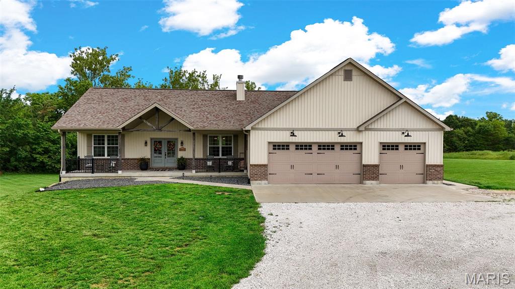 Welcome to this stunning custom ranch home built in 2018, offering over 3,000 square feet of finished living space on 3.68 private acres backing to mature trees. This property perfectly blends peaceful seclusion with convenience just minutes from town.

From the moment you arrive, you’ll be greeted by a massive covered front porch and impressive double front door entry.

Inside, the open floor plan features 9-foot ceilings and a beautifully designed kitchen complete with quartz countertops, a large center island, and stainless steel appliances (Fridge Included), all flowing seamlessly into the main living and dining areas. The main level also includes a spacious primary suite with a tile walk-in shower and walk-in closet, main floor laundry (Washer/Dryer Included) for added convenience, and two additional bedrooms.

The finished walk-out basement expands your living space and features durable finished concrete floors, a 4th bedroom, two dedicated offices or flex rooms, a bar area, and an expansive recreation space.

Step outside to enjoy the covered composite deck or the large back patio, offering multiple areas to relax or entertain while taking in the private, tree-lined setting. The oversized 3-car garage with a workshop/storage extension provides excellent space for full-size vehicles, hobbies, or additional storage. The extended gravel driveway allows for ample additional parking.

With minimal deed restrictions and plenty of room for a future outbuilding, this property offers flexibility to fit your lifestyle. Combining space, functionality, and privacy, this home delivers the acreage living you’ve been waiting for.