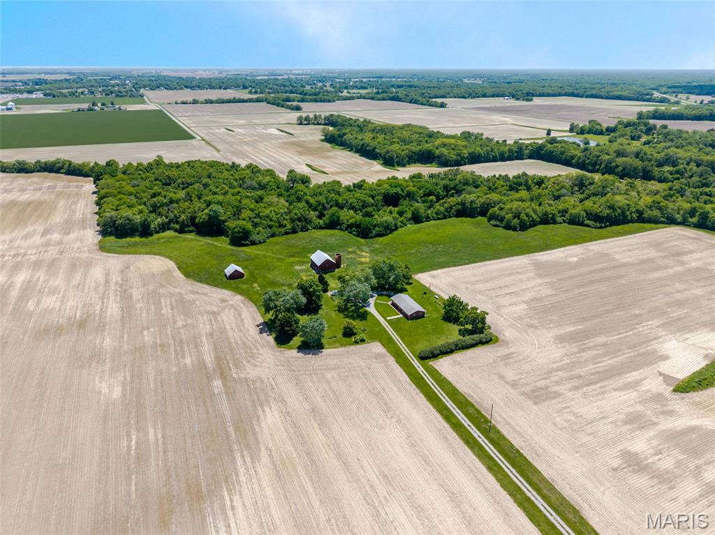 Discover true privacy and acreage on this exceptional 29.43-acre property in Mount Olive. This wooded retreat offers the seclusion and space that buyers seeking a genuine escape are searching for. With a natural creek and spring-fed water source on the property, mature trees, and three substantial outbuildings, this land provides endless possibilities for expansion, equestrian pursuits, or simply the peace of mind that comes with real distance between you and your neighbors.
The home itself is a solid three-bedroom, one-bath residence totaling 1,400 square feet with an updated kitchen featuring a large island, abundant counter space, and cabinet storage paired with stainless steel appliances. Hardwood floors flow throughout the living and dining areas as well as the bedrooms, establishing a warm foundation for the home's layout. A full unfinished basement offers flexibility for additional living space or storage, while the one-car garage provides practical utility.
This is the rare opportunity to own meaningful acreage with thoughtful improvements already in place. Whether you envision expansion, agricultural or recreational use, or simply want to build your legacy on land where neighbors are measured in acres rather than feet, this property delivers the privacy and potential you've been seeking. Schedule your showing today and own your legacy property today.