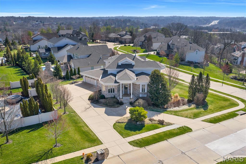 Welcome to this exceptional custom residence in sought-after Des Peres, where thoughtful design, luxury upgrades, and sophisticated craftsmanship create a truly one-of-a-kind home. Offering 5 bedrooms, 4 full bathrooms, and 2 half baths, this property combines impressive architectural features with high-end mechanical and structural improvements rarely found in homes of this caliber. The home begins with 10-foot poured concrete foundation walls and engineered LVL/steel structural framing, creating expansive open spaces with minimal support posts and a walk-out lower level. The exterior has undergone a complete architectural transformation, highlighted in mineral stone veneer masonry, replacing the original stucco with timeless, upscale curb appeal. A stamped concrete driveway, architectural stone mailbox, mature landscaping, and a new composite deck (2025) with spiral staircase leading to the patio create an ideal outdoor living and entertaining environment. Inside, the home is equipped with extensive custom millwork and cabinetry, including Bertch cabinetry throughout, inset doors, glazed finishes, a custom hood surround. The chef’s kitchen features premium appliances including Sub-Zero refrigerator, Wolf gas cooktop with downdraft, Wolf convection oven & microwave, and Asko dishwasher, along with concealed under-cabinet outlets, under-cabinet lighting, pop-up island power, and solid surface countertops throughout the home. Mechanical systems have been extensively upgraded for efficiency and reliability, including a NEW Trane HVAC system (2025), dual high-efficiency tankless water heaters, hot water recirculating system, humidification system, and 400 AMP underground electrical service with three electrical panels and whole-house surge protection. The home is fully wired for modern living with CAT5 and coax throughout, built-in speakers in most rooms, TV wiring in every room, multi-zone audio system, and lighting control system. Over 75 recessed lights with designer trim and dimmers create a warm and inviting atmosphere throughout. The walk-out lower level is an entertainer’s dream, featuring coffered ceilings, polished EnduraCrete concrete flooring, a masonry fireplace, full wet bar with true commercial beer dispenser, and a unique bathroom with urinal installation. Additional highlights include hardwood floors and staircases, cork flooring in the kitchen/breakfast/laundry areas, bamboo flooring in the office, porcelain tile baths, epoxy garage floor, central vacuum system with toe-kick sweep inlets, jetted soaking tub and multi-valve shower in the primary suite, and a HUMIDIFALL stainless mirror water feature that adds a striking design element and so much more!
