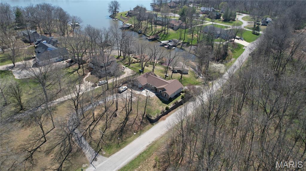 Great 4 bed, 3 bath lake home located in a beautiful cove on Governor Bond Lake. Enjoy time down on the lake with this 1 slip boat dock that has a nice deck and boathouse.  A beautifully crafted kitchen on the main level, that is great for entertaining,  features quart countertops & soft close cabinets!  Cant get better than the master suite, complemented with 2 Main floor bedrooms and a bathroom.  Lower level walk out basement,  can be additional space for your family or guests.  This amazing space is a complete 2nd residence with kitchen, family room, bedroom, full bath, and second laundry area.  And lets not forget about all the storage!  Roof is approximately 4 years old.  Don't miss out! There is so much space in the home 3600 square feet of living space, 1+ acre lot, and so much fun to be had THIS summer!