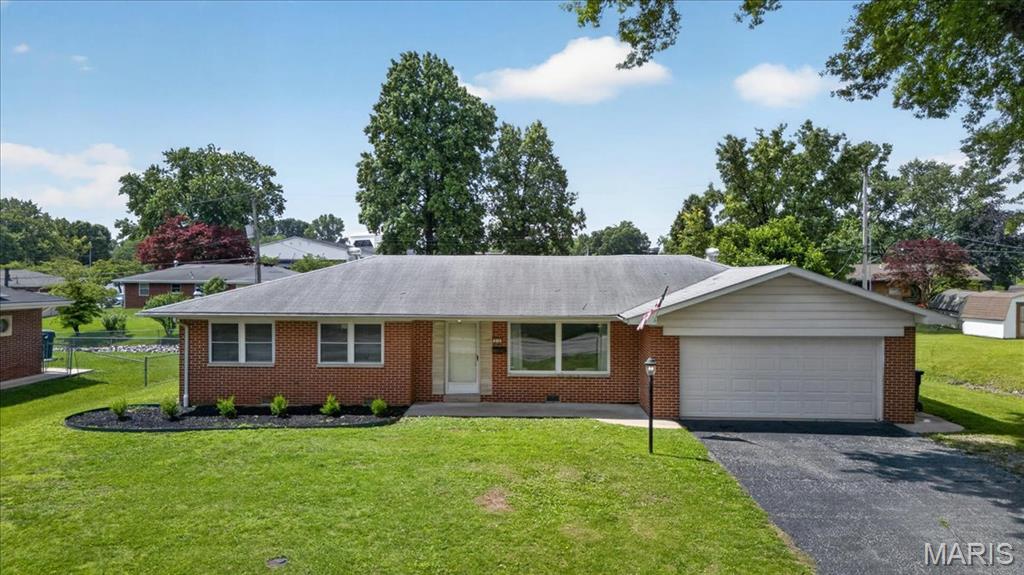 Nestled in a quaint, tree-lined neighborhood, this inviting brick ranch is rich in character and offers the comfort to make everyday living and entertaining easy.  Located just minutes from I-255, Downtown St. Louis, and Scott Air Force Base, you'll enjoy easy access to shopping, dining, and commuting while still feeling right at home.  From the moment you arrive, you'll appreciate the inviting curb appeal, expansive level lot, long driveway, and attached two-car garage.  Step inside to a welcoming living room featuring beautiful coved ceilings, a large picture window that fills the space with natural light, and original hardwood floors that continue throughout much of the home.  The dining room overlooks the backyard and flows seamlessly into the charming vintage-like kitchen, offering both functionality and timeless appeal.  Three generously sized bedrooms with ample closet space provide comfortable accommodations, while an additional bonus room offers flexibility as a home office, mudroom, sitting area, hobby room, or play space. Two full bathrooms complete the interior.  Outside, enjoy a fully fenced backyard with a concrete patio, storage shed, and plenty of room for pets, gardening, or entertaining.  St. Clair's cccupancy inspection has already been passed, making this home truly move-in ready for its next owner.  This is the kind of home you've been waiting for!
