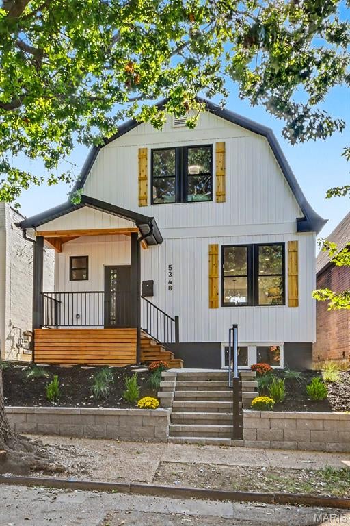 Welcome home! This beautifully renovated property was completely gutted down to the bare framing inside and out, then rebuilt with comfort, quality, and modern living in mind. Improvements include all-new plumbing, electrical, and HVAC systems. The home makes a great first impression with white siding, black accents, natural wood shutters, fresh landscaping, and a welcoming covered front porch. Step inside to a bright living room filled with natural light from the oversized windows. The electric fireplace with floor-to-ceiling wood slat detailing adds warmth and character, while the light flooring and modern black staircase railing bring everything together. A convenient half bathroom is located on the main floor near the living room. The kitchen offers quartz countertops, stainless steel appliances, plenty of cabinet storage, a tile backsplash, and a large island with seating and a built-in microwave/oven combination. The nearby dining area makes it easy to enjoy meals or entertain guests.
Upstairs are three comfortable bedrooms and a beautifully finished full bathroom with gold fixtures and a tiled tub and shower enclosed by black-framed glass doors.
Out back, the rear porch overlooks a large, freshly landscaped, fully fenced yard. A gated concrete parking pad provides convenient off-street parking. The clean, unfinished basement offers plenty of storage and room for future possibilities. This move-in-ready home combines the charm of an established neighborhood with the fresh feel of new construction. Schedule your showing today!