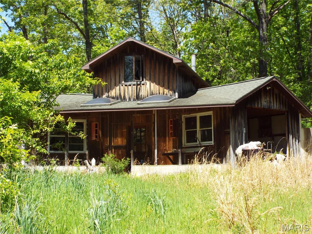 Endless potential awaits on this picturesque 18.55+/- wooded acres! Perfect for outdoor enthusiasts, hunters, or anyone looking for a private fixer-upper project, this property is a true diamond in the rough. The estate consists of three separate structures: a cozy 1-bedroom, 1-bath main residence, a standalone private sauna building, and a massive 930 sq. ft. workshop/garage featuring a spacious upper-level bonus loft (perfect for a potential extra bedroom or hobby space). The home has been vacant and is being sold entirely in as-is condition—bring your toolbelt and vision to restore this unique property to its full potential! Schedule your tour today.