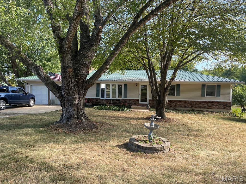 One owner, custom built home.  Remodeled to Open up living room, kitchen and dining area.  Propane fireplace and bay window in living room.  Kitchen features an island with electric cook top and seating, double built-in ovens, pendulum lighting and custom-built cabinets.  Dining area has a bay window and French door leading to the back deck.  Primary bedroom features a walk-in closet and primary bath has tile, walk-in shower.  Two additional bedrooms.  Half bath off hallway.  Laundry room.  Attached 2-car garage with openers.  Detached 22X20 garage with heavy, manual garage door and dirt floor.  Sitting on 2.2 +/- manicured acres in a rural subdivision.