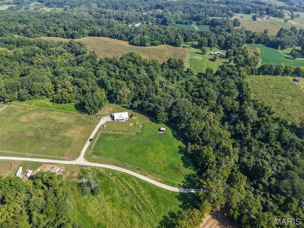 Newly built farmhouse on approximately 13 acres. Welcome to your dream country property. This beautiful acreage offers an abundance of wildlife, 2 fenced pastures, and the 4 bedroom, 2 bath home built in 2025. Property is well suited for horses, livestick, equipment or hobbies. If you are looking for multigenerational space for your family, this can be purchased along with 26066 Elsah Hills, which consists of another home situated on 27 acres +/-.