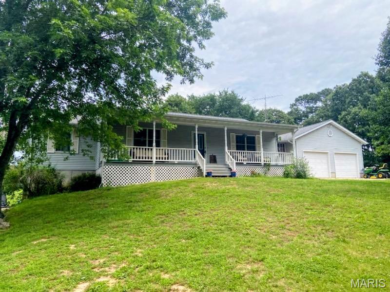 Quiet rural setting, yet just minutes to shopping and highways.  The 1.7 acre lot offers a shed outbuilding, chicken coop, and fire pit area.  The home features a large living room with vaulted ceiling.  All 3 bedrooms are generously sized, primary bedroom with sliding door to full bath.  Additional full hall bath.  Main floor laundry room with door to back yard.  Bonus breezeway room has endless possibilities.  Lower level has family room, gas fireplace, wet bar with cabinets, a full bath, abundant storage room, and walk out to patio.