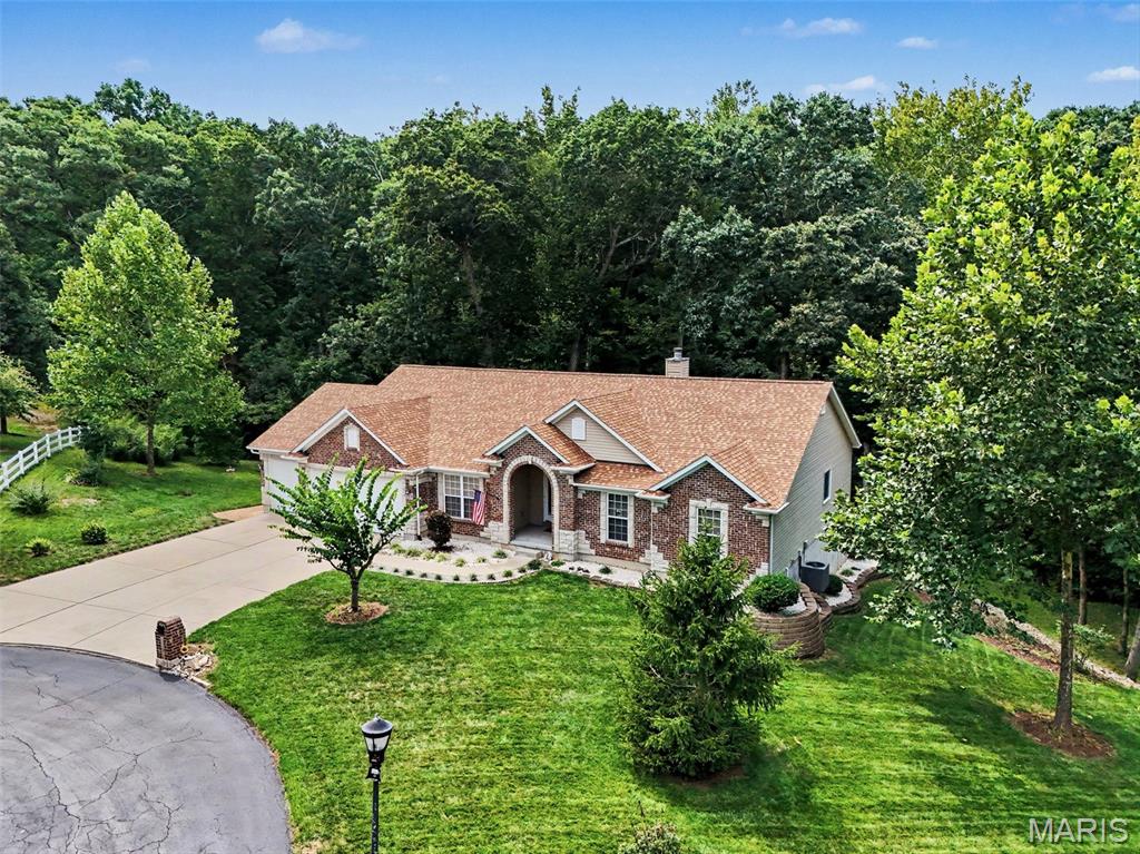 Discover an expansive lifestyle opportunity at 6300 White Clover Drive!  Built in 2006, this exquisite +-2024 sq foot atrium ranch with brick and stone front is nestled quietly on over an acre of land in a cul-de-sac backing to mature trees!  With three well-appointed bedrooms, 2 full bathrooms and a main floor laundry, this residence provides an exceptional opportunity for the growing family and an excellent investment opportunity to finish the lower level.  Pride of ownership is evident from the arched entry to the landscaping to the walk-out basement.  With attractive features like a 3-car garage, large patio, and screened back deck this is one you'll not want to miss. Additional features like large room sizes, open vaulted floor plan, vaulted ceilings, granite counters, separate dining, gas starter fireplace & walk-in closets will surely impress any buyer.  This property invites you to envision a life of spacious comfort and endless possibilities in one of the areas premier subdivisions. Don't miss the community fishing lake!