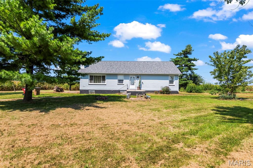 Country living is calling! Situated on 2.59 acres and surrounded by wide-open farmland, this 3-bedroom, 1-bathroom one level home offers plenty of space inside and out. The spacious living room features abundant natural light, attractive flooring, and a cozy  wood-burning fireplace. The roomy eat-in kitchen provides ample cabinetry, generous counter space, and plenty of room for gathering around the table. All three bedrooms are conveniently located on the main level, along with a full bathroom featuring a tiled shower and generous vanity. Outside, mature shade trees, open pasture, a pond, and multiple outbuildings create exciting possibilities for animals, hobbies, equipment, or extra storage. Fenced area is ready for animals! Property is on public water, propane, and septic. If you’ve been dreaming of peaceful country views and room to make a property your own, this one deserves a closer look!