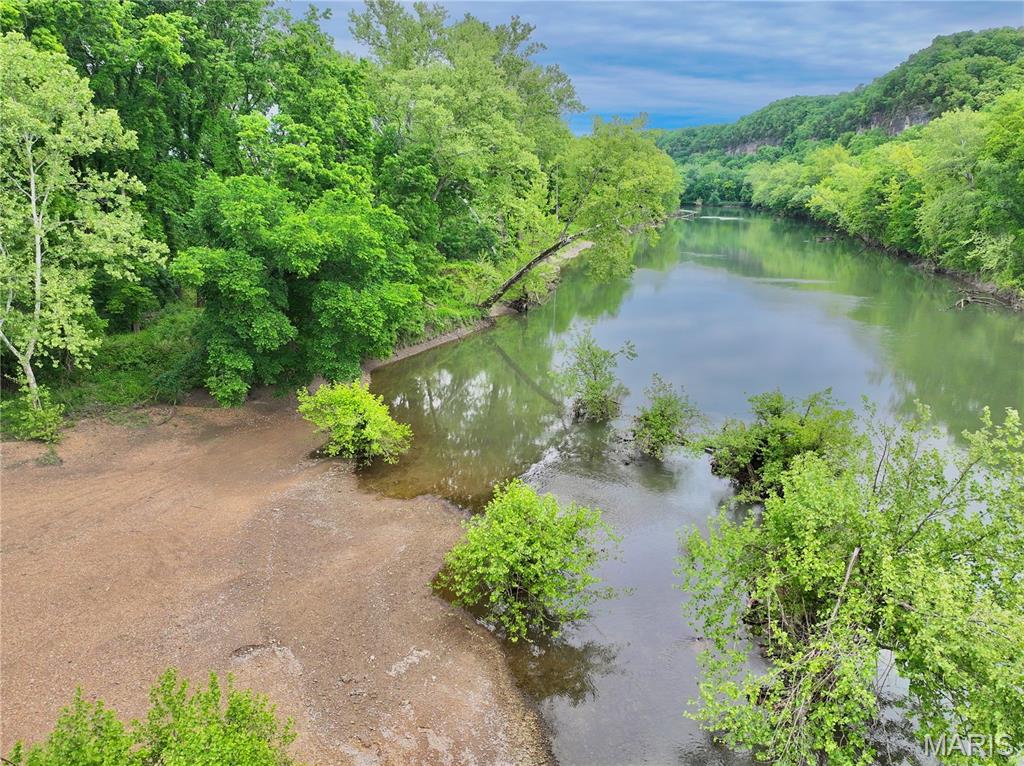 16.5 acres on the legendary Gasconade River just over 3 miles north of I-44 offering a rare opportunity to own a private stretch of riverfront property in the heart of the Ozarks. This tract features a beautiful blend of open river bottom ground and mature timber, creating the perfect setting for recreation, a weekend getaway, or your future dream home. A prime build site overlooking the river bottom is already in place with power on the property, making this tract ready to enjoy from day one.
A gravel drive leads straight from the build site down to a gorgeous gravel bar along the river’s edge, all within walking distance from your future cabin or home. Whether you enjoy fishing, floating, swimming, or simply relaxing by the water, this private stretch of the Gasconade delivers the kind of peace and scenery that’s becoming harder to find. The elevated build location provides beautiful views overlooking the river bottom while still offering quick and convenient river access.
The property is accessed through an electric gate providing both security and convenience, and the surrounding area offers outstanding wildlife habitat with the seclusion buyers are searching for in today’s market. Additional adjoining acreage is also available upon request, allowing room to expand or customize your ideal riverfront retreat.
If you’ve been searching for build-ready acreage with direct access to one of Missouri’s most scenic rivers, this property deserves a closer look.