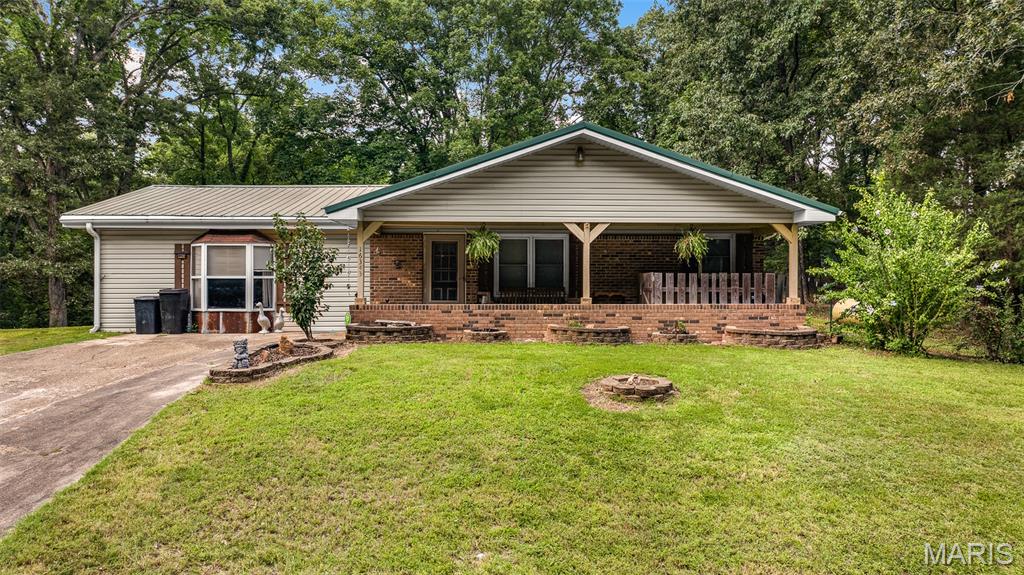 Welcome to your own private retreat just minutes from Dexter! This one-of-a-kind 3-bedroom, 2-bath home is filled with rustic farmhouse charm and custom craftsmanship you simply don't find every day.
From the moment you step inside, you'll be captivated by the warm natural wood finishes, exposed beams, and inviting spaces designed for both everyday living and entertaining. A stunning double-sided wood-burning fireplace creates the perfect focal point, offering cozy ambiance to both the living room and kitchen.
The spacious den/rec room features soaring ceilings accented with impressive custom beams, creating a dramatic space that's perfect for family gatherings, game nights, or simply relaxing. Throughout the home, thoughtful custom touches and handcrafted details give it a timeless character that's impossible to replicate.
Step outside and enjoy the peaceful setting from either the covered front porch or the back deck overlooking the property. Whether you're sipping your morning coffee, enjoying an evening around the fire, or watching the abundant deer and wildlife wander through, this home offers the quiet country lifestyle so many buyers are searching for.
If you've been dreaming of a home with authentic rustic character, cozy farmhouse warmth, and beautiful outdoor views, this is one you won't want to miss.