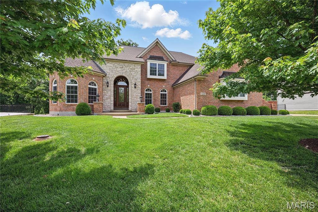 Welcome to this light filled spacious two-story home built by Levinson Homes in Wildwood which offers over 5500 sq. ft. of spacious living situated on a 1.18 acre lot on a cul-de-sac.  This home is located in the desired Wynncrest subdivision in the high ranking Rockwood School District. Upon entering the home you see the dining room with a tray ceiling, office/study with custom built-ins and vaulted ceiling (13ft.), and the expansive light filled great room featuring  a soaring vaulted ceiling(18 ft.), wood burning  fireplace (never used) and a “forest” view  out the wall of windows.  The kitchen boasts stainless appliances, granite counters, 2 tier island, walk-in pantry, breakfast room, hearth room with vaulted ceiling (12 ft. ), gas fireplace and custom built-ins with access to the spacious deck.  Laundry room located off kitchen.  Main floor primary suite with tray ceiling and 2 walk-in closets and “forest” view.  Second floor has 2 bedrooms with a J&J bath and one bedroom with ensuite bath. Finished lower level has 1 bedroom with ensuite bath, bonus room that can be another bedroom, office, or playroom. There are also 2 large storage rooms one with rough in plumbing.  A large 3 car garage with storage.