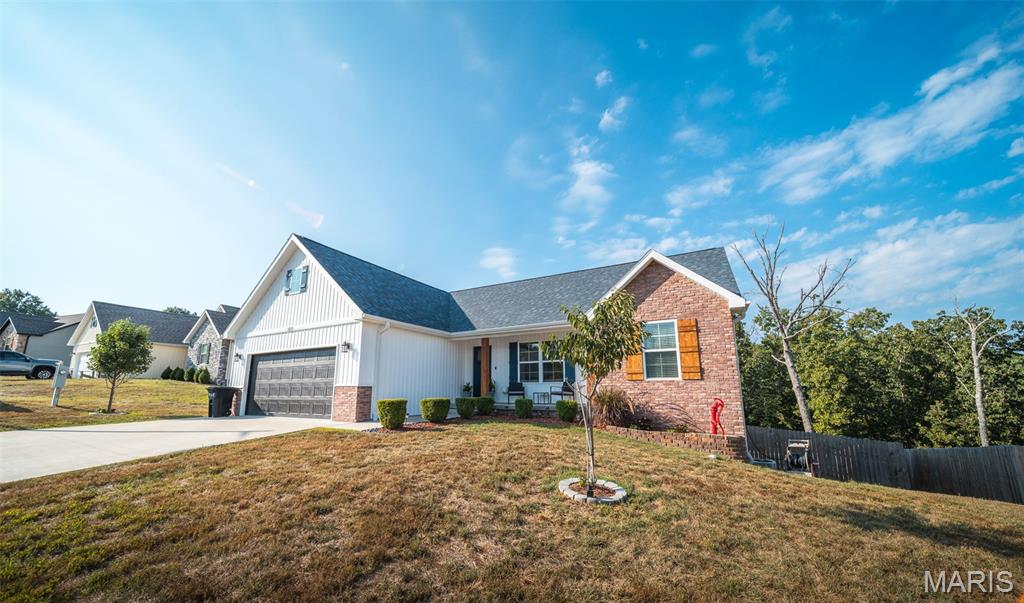 Welcome to this stunning 4 bedroom, 3 bath home where modern design, quality craftsmanship, and thoughtful details come together beautifully. Situated on a desirable .45 acre lot in the Waynesville School District and conveniently located near Fort Leonard Wood, this home offers both comfort and convenience. From the moment you step inside, you’ll notice the exceptional finishes, including luxury vinyl plank flooring, gorgeous granite countertops, custom cabinetry, a custom-built pantry, stylish fixtures, mirrors, and carefully selected appliances. The spacious layout features vaulted ceilings and an inviting design perfect for everyday living and entertaining. Step outside onto the back deck and enjoy the peaceful outdoor setting. Additional highlights include a 14.5 SEER heat pump with electric furnace backup and an oversized garage featuring a durable epoxy-coated floor. Beautifully finished and ready for you, this home is a must-see!