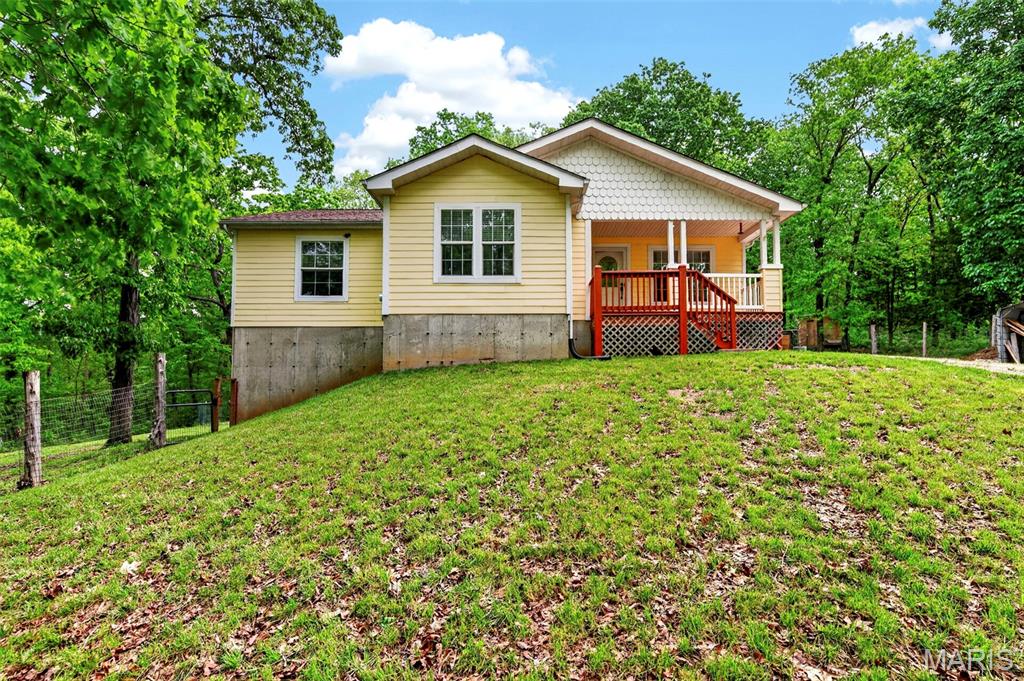 Nestled within the highly desirable Hillsboro School District, this exceptional country retreat spans 8.48 private, wooded acres—offering a rare combination of tranquility, space, and modern convenience.

This well-maintained ranch home features approximately 1,957 square feet of thoughtfully designed living space with a bright, open floor plan. Inside, you’ll find quality updates including granite countertops, crown molding, and durable laminate flooring throughout. A welcoming covered front porch leads into a spacious living area that flows effortlessly into the dining space and well-appointed kitchen—ideal for both everyday living and entertaining. Newer furnace, air handler, water heater, and water softener add desirable peace of mind.

The home offers four bedrooms and two full bathrooms, including a comfortable primary suite complete with a walk-in closet. A split-bedroom layout enhances privacy, while main-floor laundry and generous storage add to the home’s functionality.

Step outside to an expansive back deck overlooking peaceful, wooded surroundings—perfect for relaxing or hosting gatherings. The walkout lower level, featuring French doors, multiple windows, and a roughed-in bath, provides excellent potential for additional finished living space.

The property also includes a 26x24 detached metal outbuilding with horse stalls and an attached carport, making it well-suited for hobbyists, livestock, or extra storage.

Beautifully maintained and move-in ready, this property offers the ideal balance of rural charm and modern comfort—an outstanding opportunity on Flicker Lane.