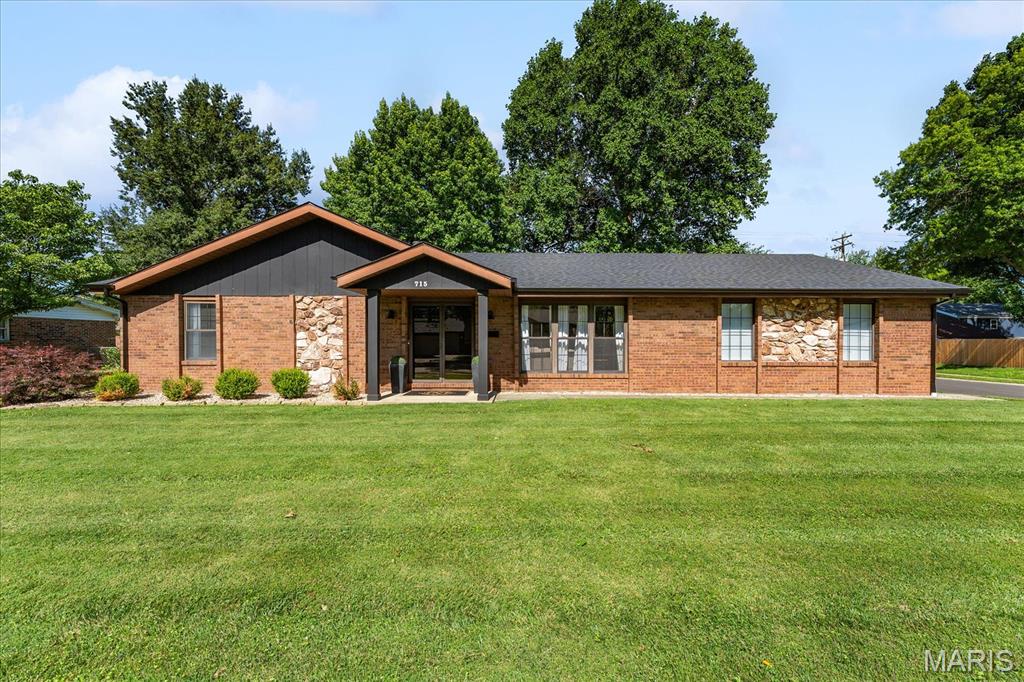 Beautifully reimagined 3 bed, 2 bath brick ranch offering 1,929 sq ft of thoughtfully updated, move-in-ready living space on a spacious corner lot in O'Fallon.

Blending timeless curb appeal with modern updates throughout, this home welcomes you with a bright and open layout designed for both everyday comfort and entertaining. The spacious living room features a stylish custom dry bar, creating a standout space for hosting. A second living area offers a cozy retreat anchored by a floor-to-ceiling painted stone fireplace.

The refreshed kitchen flows seamlessly into the dining area, offering a functional and inviting layout. The private primary suite is filled with natural light and includes an ensuite bath and dual closets for excellent storage. A dedicated laundry room adds convenience with custom folding counters and built-in shelving.

Another highlight is the fully enclosed 3-season sunroom with a wood-paneled ceiling—perfect for year-round relaxation while overlooking the expansive fully fenced backyard, complete with a storage shed.

Ideally located near downtown dining, parks, and within O’Fallon school district, this home offers the perfect blend of style, space, and location.