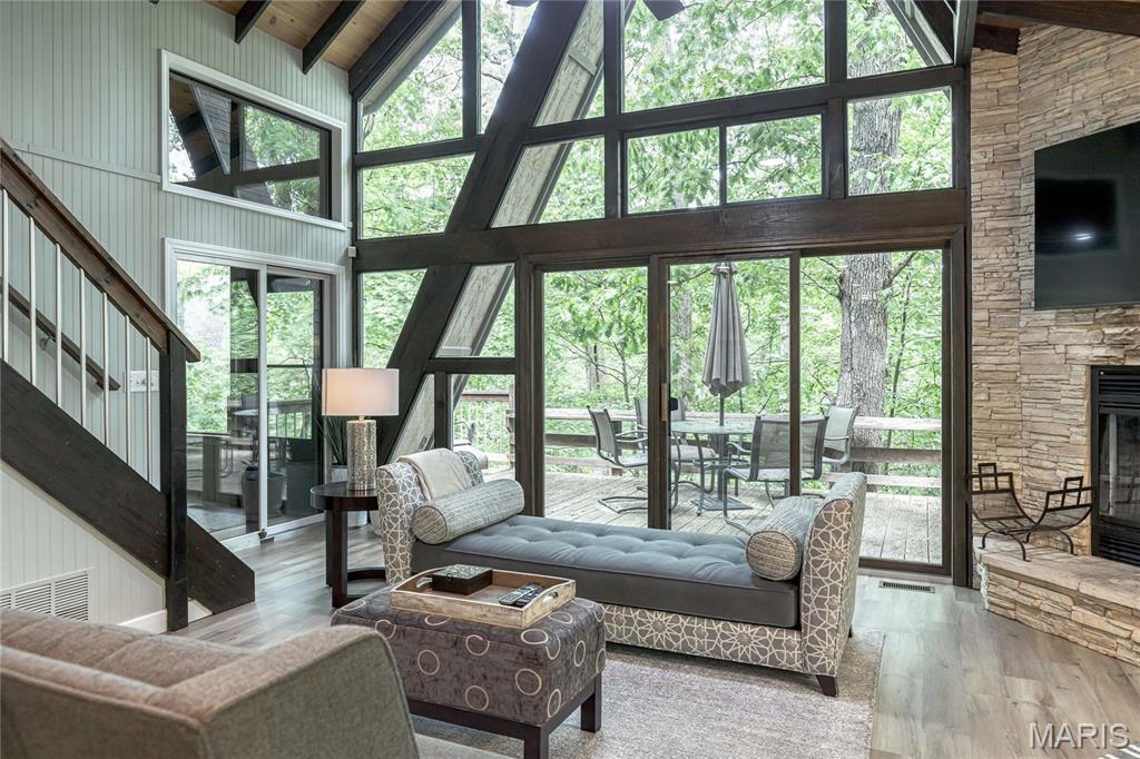 Not your typical Innsbrook chalet—this architect-designed retreat delivers a clean, modern aesthetic with a true “NYC in the woods” feel. Thoughtfully reimagined and completely turnkey (everything included), it’s a refined escape for those who want the setting of Innsbrook without the traditional rustic style. The open-concept great room blends living, dining, and kitchen spaces with dramatic walls of glass and a striking fireplace, bringing in natural light and framing the surrounding trees. The updated kitchen features modern cabinetry, stainless appliances, and a layout designed for both everyday use and effortless entertaining. The main-floor primary suite offers a true spa-like experience, with an expanded bath featuring dual vanities (two separate sink areas), a walk-in shower, and a whirlpool tub. A main-floor laundry adds convenience. Upstairs, a versatile loft provides additional space for guests, a home office, media lounge, or a private yoga/meditation retreat. Outdoor living is equally compelling, with a screened porch and deck that feel fully immersed in the woods—private, peaceful, and connected to nature. With strong rental potential and a design-forward approach rarely found at Innsbrook, this is a rare opportunity to own a move-in ready retreat that stands apart. Brand new roof installed April 2026.