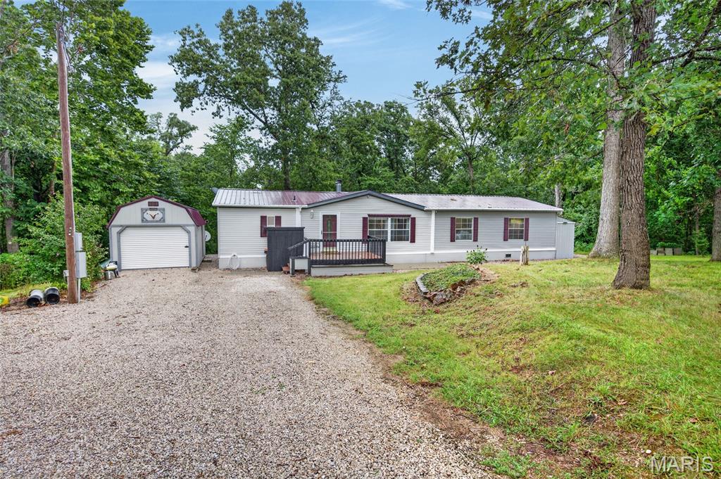 Country living doesn't get much better than this! Situated on just over 10 acres m/l, this beautifully maintained 3-bedroom, 2-bath home offers the perfect mix of modern updates, privacy, and room to roam. Conveniently located on a state-maintained highway, you'll enjoy easy year-round access while still feeling tucked away from neighboring properties.

From the moment you pull in, it's easy to see the pride of ownership. Inside, you'll find a spacious living room with a beautiful wood-burning fireplace, creating the perfect place to gather on cool evenings. The open layout flows into the dining area and the fully remodeled kitchen, featuring abundant cabinetry, a large pull-out pantry, updated appliances, and plenty of counter space.

The oversized primary suite offers plenty of room to unwind and includes a spacious bathroom and a large walk-in closet with access from both the bedroom and bath. Two additional generously sized bedrooms, each with walk-in closets, and an updated hall bath provide plenty of space for family or guests.

Recent improvements include beautiful laminate flooring, a newer roof, and newer HVAC, giving you peace of mind for years to come.

Outside, you'll find two outbuildings that provide excellent storage, with one offering heat, air conditioning, and electricity—perfect for a workshop, hobby space, or whatever fits your needs.

The back five acres have been thoughtfully cleared to establish food plots, creating an excellent habitat for wildlife. Deer and turkey have been harvested on the property year after year, making this an exceptional opportunity for hunting enthusiasts.

Whether you're looking for a full-time residence, a weekend escape, or a place to enjoy everything country living has to offer, this property is ready to welcome you home.