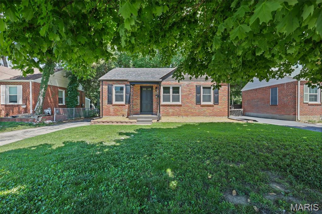 Newly remodeled 2 bed 2 bath bungalow!  Walk in to admire the beautifully refinished hardwood floors throughout. The faux fireplace gives this homes family room an exciting and modern touch of character. The fully remodeled kitchen features a breakfast bar, quartz countertops and brand new stainless steel appliances. The bright and airy main floor bathroom features a floor to ceiling tiled shower/tub combo and ceramic tile floors. New tubs, toilets, vanities and faucets in both bathrooms. The clean and inviting basement features an oversized bonus bathroom and storage. The back patio of this home offers an awning covered patio. The perfect place to sit and enjoy the view of the oversized lot full of beautiful mature trees. In addition, this home features updated plumbing including a brand new stack and a brand new water heater. Updated electric service, panel and outlets. Updated light fixtures and ceiling fans throughout. Brand new roof, windows, and gutters, and AC unit.