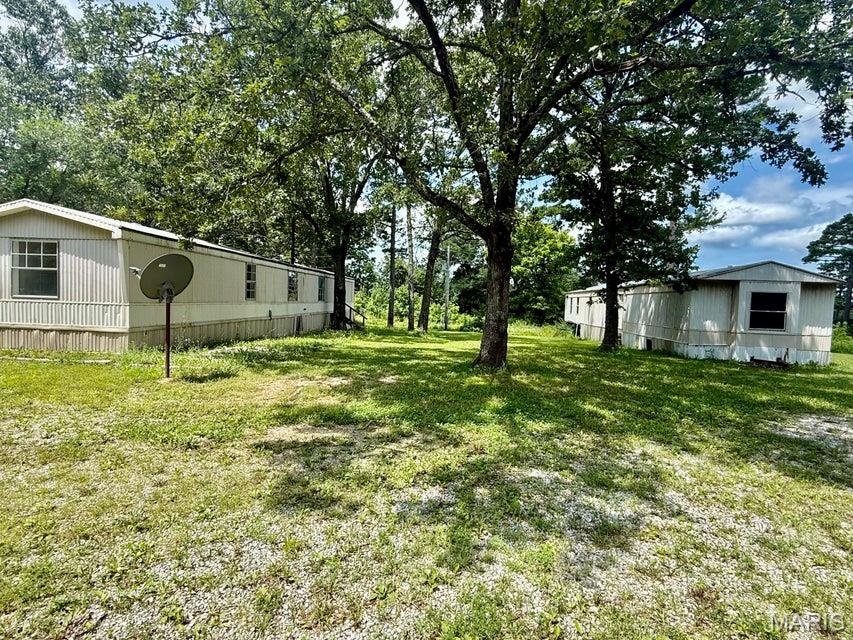 Investment opportunity just outside Houston, Missouri! This 2.63± acre unrestricted property offers excellent potential for a variety of uses. Whether you're looking to develop additional mobile home sites, create a rental property, or invest in land with existing infrastructure, this property is ready for your vision. Improvements include four water meters and two 1,000-gallon septic tanks, providing a solid foundation for future development. Two mobile homes are currently located on the property and are not currently occupied, but with a little updating they could be returned to service as income-producing rentals. Conveniently located just outside the Houston city limits, this property offers the freedom of no restrictions while remaining close to town amenities. With existing utility infrastructure already in place and room for future possibilities, this property is an excellent opportunity for investors or anyone looking to build their rental portfolio.