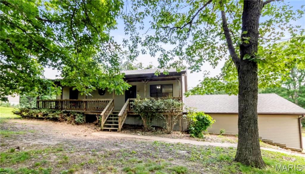 Welcome home to this versatile property set in a peaceful, tree-lined location in the heart of Gerald. Mature trees provide a private feel while keeping you close to Gerald City Park and local amenities. The full-length front porch offers a welcoming outdoor space ideal for relaxing, visiting, or enjoying the outdoors. 

 Inside, soaring ceilings in both the living room and primary bedroom create an open, light-filled atmosphere. The main level features 3 bedrooms and 2.5 bathrooms, including a spacious primary suite. Recent updates include fresh interior paint, upgraded main-level light fixtures, and a remodeled shower in the primary bathroom.

The partially finished lower level adds exceptional flexibility with a private sleeping room and full bathroom with a step-in shower —ideal for guests, multi-generational living, a home office, or hobby space. Additional features include an oversized laundry room, and a hobby/workshop with a garage door, and unfinished space that can be converted to more living space. 

Storage is abundant throughout the home, with multiple large closets, an oversized attached two-car garage, and a detached shed perfect for equipment, recreational vehicles, or additional workspace.

The backyard includes a fenced area suitable for pets. The surrounding mature trees enhance the sense of privacy rarely found within city limits. With flexible living areas, extensive storage, recent updates, and a convenient location near parks, schools, and community amenities, this property offers space and versatility.  A Choice Home Warranty is also included for peace of mind.