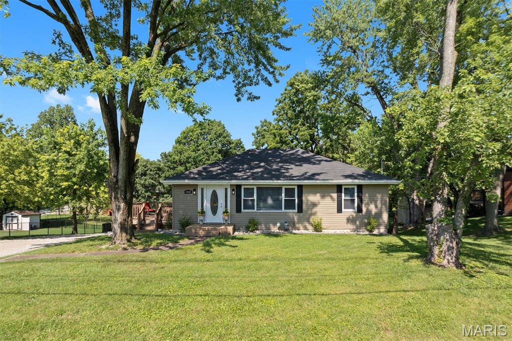 Updated ranch offering 4 bedrooms, 2 full baths and more than 2,000 square feet of finished living space on a nearly half-acre lot with mature trees. The bright main level features a spacious living room and an updated kitchen with granite countertops, stainless steel appliances, recessed lighting, abundant cabinetry and distinctive accent finishes. Three bedrooms and a full bath complete the main level.
The full finished basement expands the living space with a large family or recreation room, built-in cabinetry with beverage storage, a fourth bedroom, full bath, separate office and utility area. Outside, enjoy a generous deck overlooking the expansive backyard, along with a detached two-car garage providing additional parking, workspace and storage.
Located near shopping, dining, parks and major routes serving the Metro East and St. Louis area. Nearby recreational destinations include Woodland Park, Willoughby Heritage Farm and the Collinsville Sports Complex. With refreshed interiors, flexible finished space, a large lot and substantial garage, this property is ready for its next owner. Schedule a showing today.