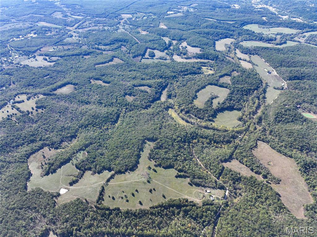 Absolutely an incredible opportunity to own a piece of property that has been owned by one family for decades. This ranch is absolutely beautiful and has so many interesting features and history. There are two springs on the farm. Long Spring is the bigger of the two and is located on the famous Trail of Tears this farm with the large flowing spring was instrumental in the history of the trail. There is approximately 90+/- acres of lush well taken care of pasture with the balance being mature woods. With all of these incredible qualities in a farm you can just imagine the abundance of wildlife. There are caves and bluffs and ponds. There are two houses one that could easily be used as a home or cabin while you build your own cabin or house with the many building sites and the other one you could easily renovate. Long Spring or Uncle Rays farm is a property that deserves the respect of a landmark that there are just not many farms of this size with this kind of water that has been this well taken care of anymore. Located just outside of Steelville which is considered the floating capital of the midwest and all of the recreational activities in the area and about an hour and half SW of St. Louis.