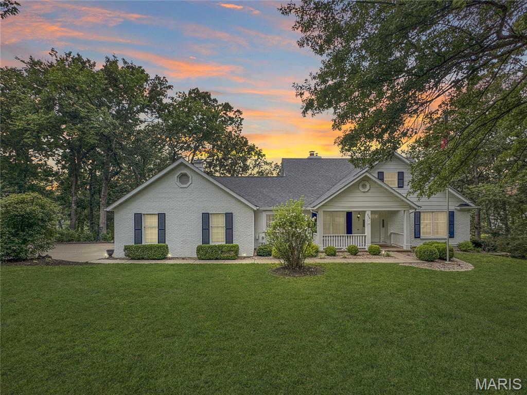 This impressive 4-5 bedroom, 5 bath home (3 full & 2 half) is inviting as soon as you walk in from a large front porch.  The Entry foyer that opens to the stunning 2-story great room with a beamed vaulted ceiling and a 2-story double-sided gas fireplace, and a elaborate dining room for the largest of gatherings with a coffered ceiling and stunning crown molding. The 2nd area of the great room has a built-in bar and doors to the covered deck for everyone to enjoy. To the left of the great room and dining room is the spacious kitchen with beautiful cabinetry, stainless steel appliances, granite countertops, and a breakfast area that has plenty of daylight, and a large coffee bar with cabinets and a sink. The large mudroom/laundry is off the garage and has a door to the driveway and side yard, along with a half bath. Off the other side of the house is the front bedroom/office with a built-in desk and a closet. The primary bedroom has plenty of light from the windows and the doors to the deck. The primary bath that is roomy and bright with double vanities, a large walk-in shower and walk-in closet. Upstairs, you will find 3 bedrooms and a full bath. The front bedroom has a vaulted ceiling and eyebrow window for additional light. This room also has 2 large areas for additional storage. The 2 staircases that take you to the Upper Level & Lower level are open and spindled. The Lower level has a rec room and a family room with an electric fireplace/stove and huge built-in bar with doors to the huge patio covered by the deck above. Additional areas in the Lower Level for storage are a dream you have been waiting for: 4 sets of built-in shelves, a cedar-lined closet, and an additional utility room. Off of the patio area is also an additional outside storage room for all the lawn equipment or patio/deck furniture. The well-manicured yard is private and has seasonal views. All this makes this home a perfect home for everyone to enjoy! Just minutes from town. Come See!