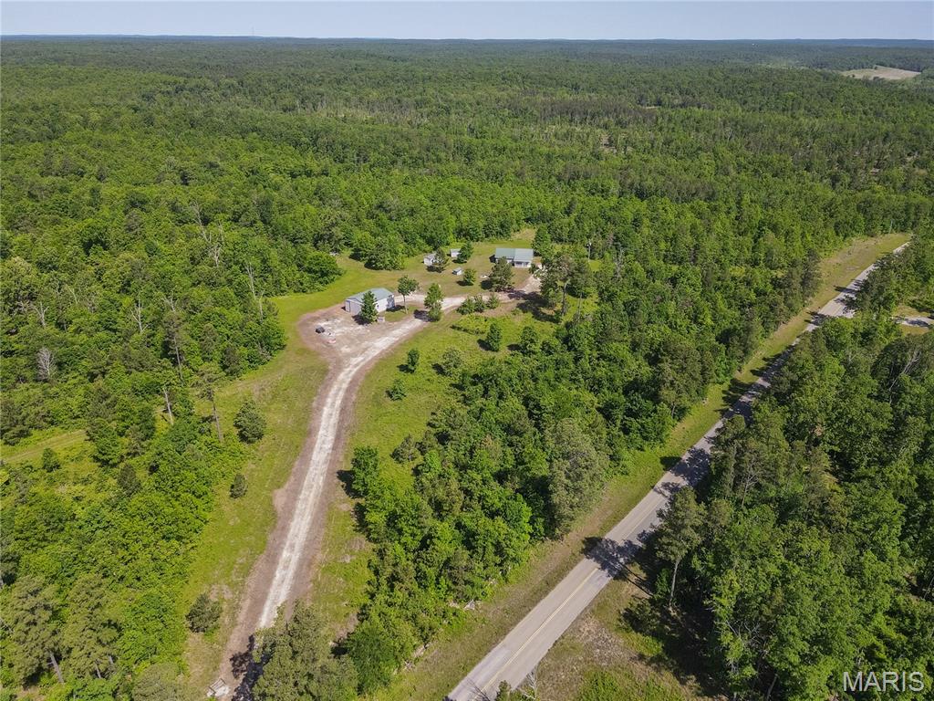 385 ac +/- of proven hunting ground for sale in Ripley County, MO - Intensely managed for approx. 10 years, this expansive Ozark hill farm is turn-key ready for you to make your own priceless outdoor memories. Located on a quiet paved road behind a gated access and perched atop the mountain, enjoy the comforts of home away from home offered by a 3 bedroom cabin. Relax on the back porch and enjoy the scenic views across the Ozark Vista. A variety of outbuildings including a nice 40x30 insulated shop with concrete floor and electric provide ample storage and work space. Adjoining a couple thousand acres of State lands and only a mile from several thousand acres of Mark Twain National Forest and a short drive to Scenic Current River / Big Springs National Park. A series of well maintained trails allow a full sized vehicle to navigate this labyrinth of a game haven. 7 large professionally maintained food plots with countless stands and ritzy hunting blinds. Simply too much to list.