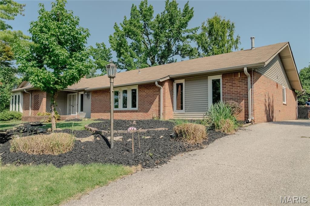 Welcome to this charming 4-bedroom, 2-bathroom slab ranch home in the sought-after Oak Tree Farm neighborhood, located in the highly desirable Parkway School District! Inside, enjoy continuous wood flooring throughout and beautiful ceramic tile in the dining area. The sunken living room features a cozy fireplace, wall-to-wall mirrors, and atrium doors topped with custom stained glass that lead out to the patio. The fully equipped kitchen showcases granite countertops and stainless steel appliances, seamlessly opening to a comfortable family room featuring a second fireplace ideal for entertaining and relaxing. Don't miss this Ballwin gem!