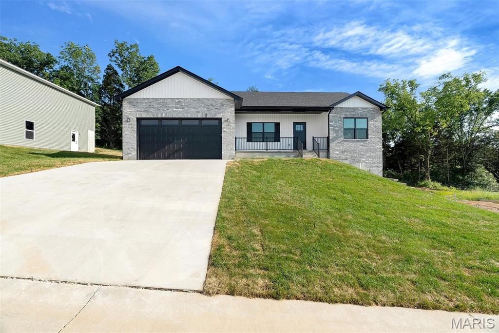 THE BUILDER IS PUTTING THE FINISHING TOUCHES ON THIS BRAND NEW HOME! A divided 3x2 ranch showing off a Grand kitchen w/ a huge island, a LG composite sink & elevated breakfast bar, loads of cabinets, awesome granite tops, LVP flrs, stainless front microwave & dishwasher, MF laundry near beds 2 & 3 & more. Glass slider door at the dining rm to deck w/ steps to a 12'x10' patio. Vaults carry through the kitchen, dining and the great rm.  A lovely entry w/ lg coat closet & splendid rail system to the lower level. Primary w/ lg walk-in closet, oversized vanity w/ granite top, gorgeous walk-in tile shower & glass slider door. The 2ndary beds are nice size & share a hall bath w/ a tub/shower & granite top vanity. Very spacious walk-out basement w/ full bth rough-in & more. The exterior combo of gray/white brick, vertical board & batten white siding, a lg covered front porch, black shutters & accents, black garage door w/ glass windows & white horizontal vinyl lap siding on 3 sides is amazing.